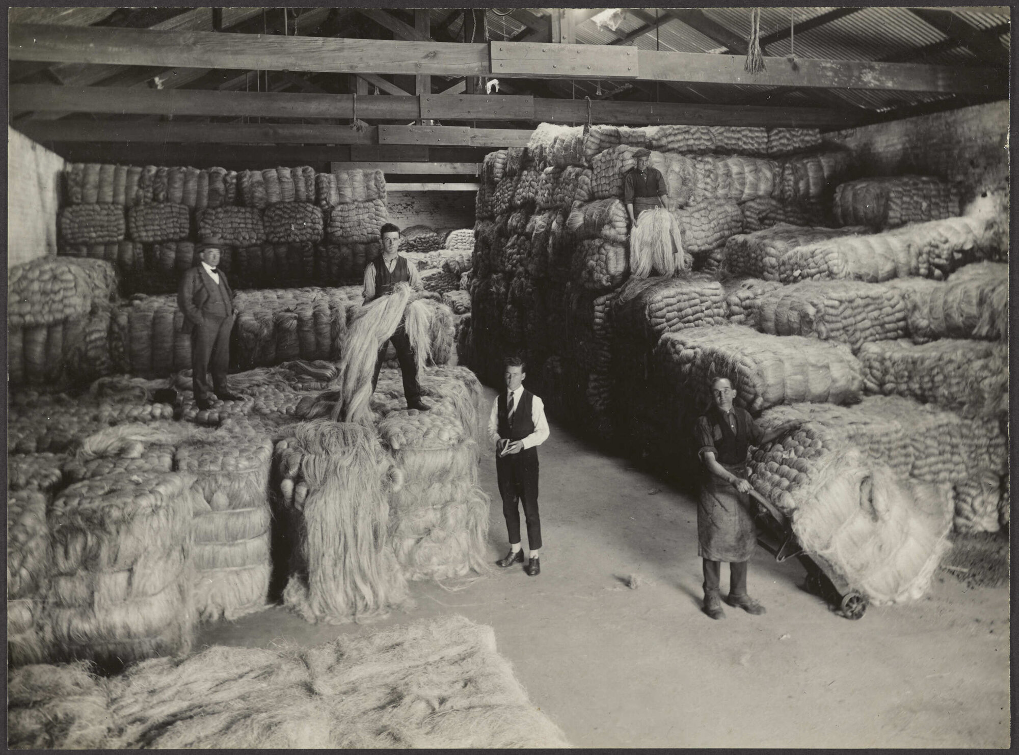 Manager and workers with bales of fibre in Donaghy's factory warehouse