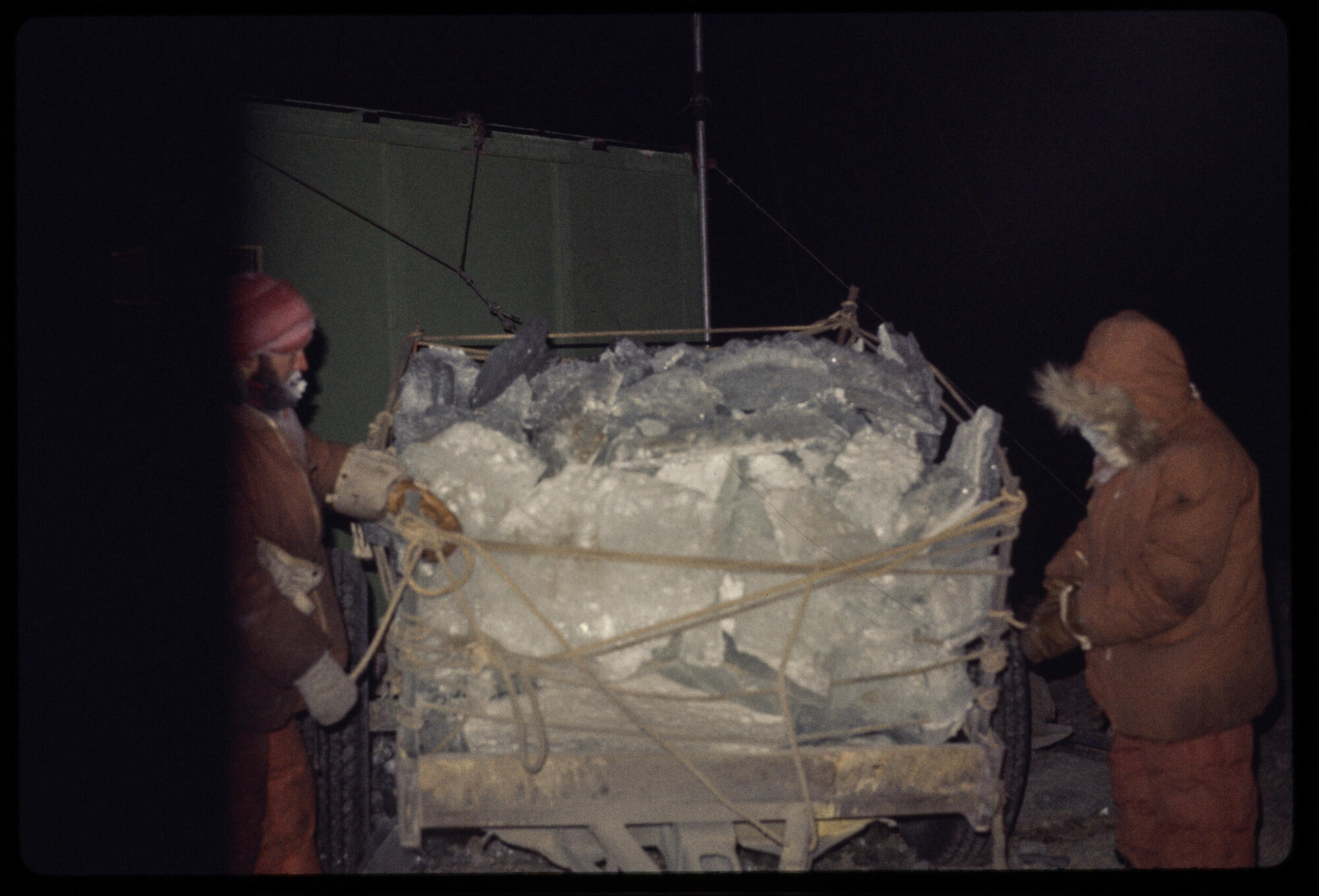 A trailer load of ice arrives at station in winter