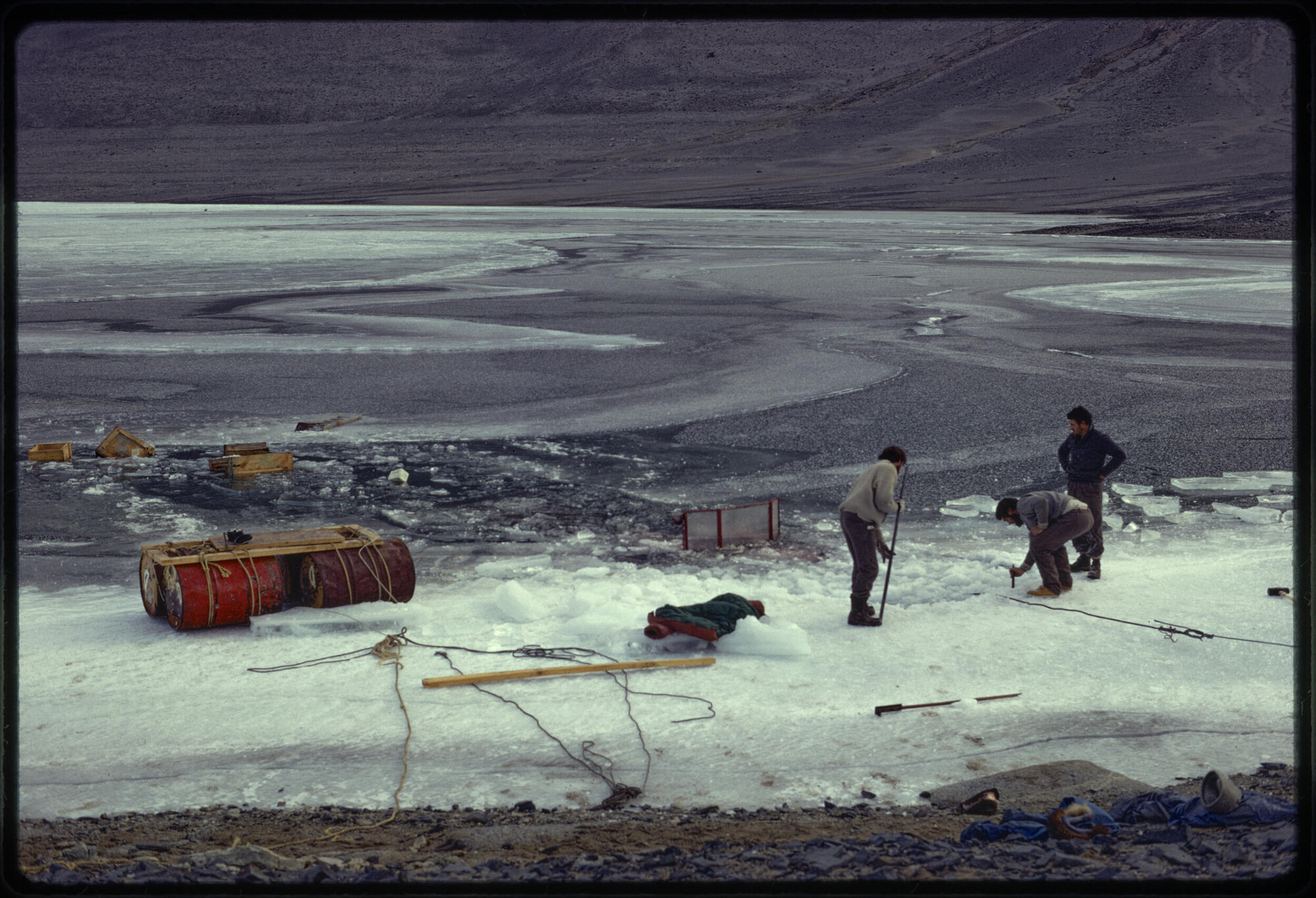 Tractor and trailer resting on bed of lake
