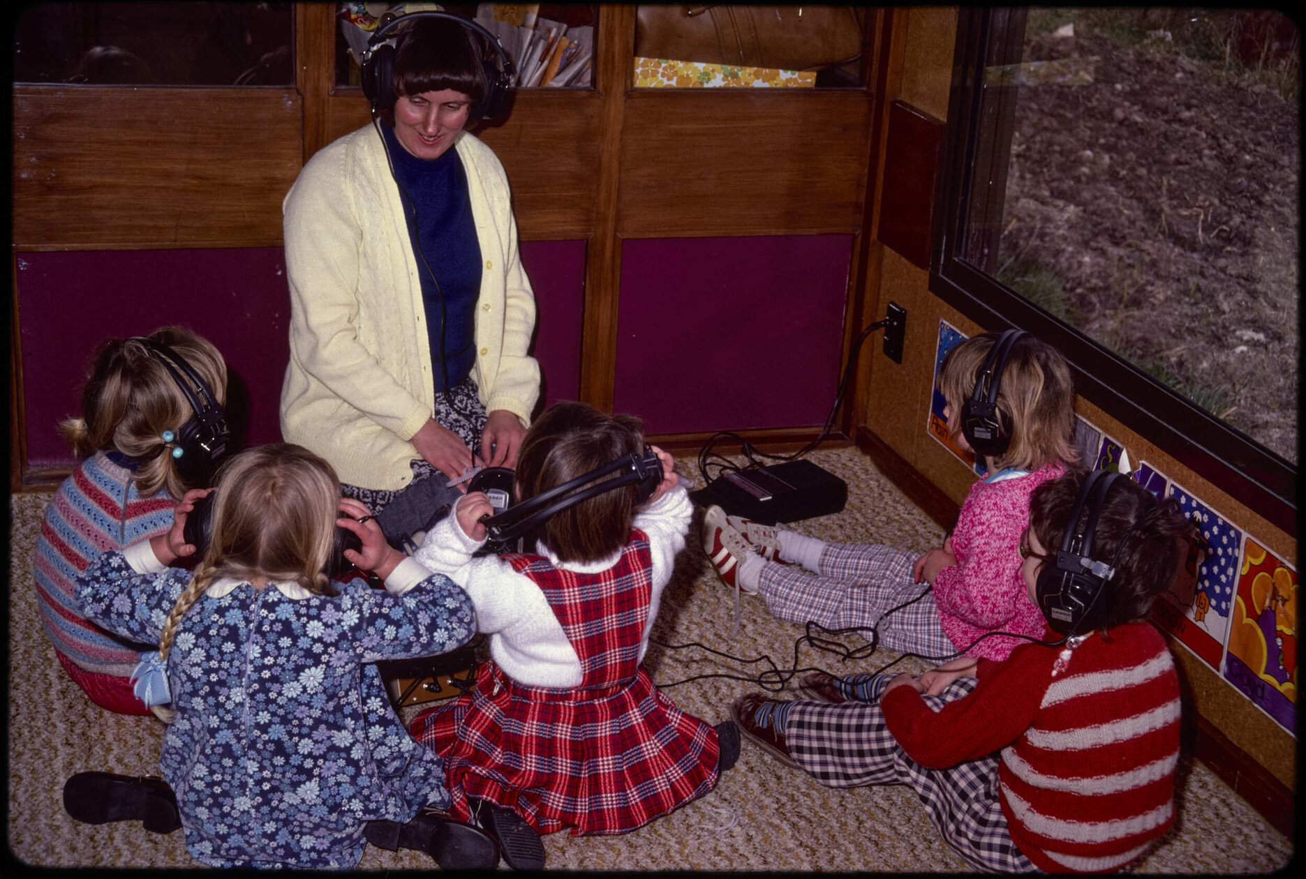 Teacher and children wearing headphones
