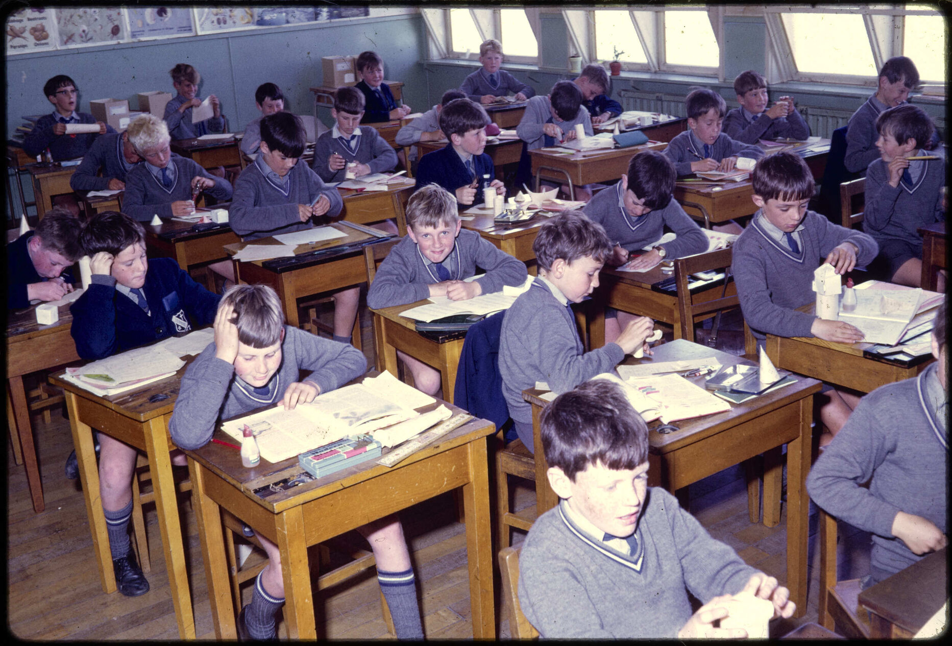 Boys seated at desks in classroom