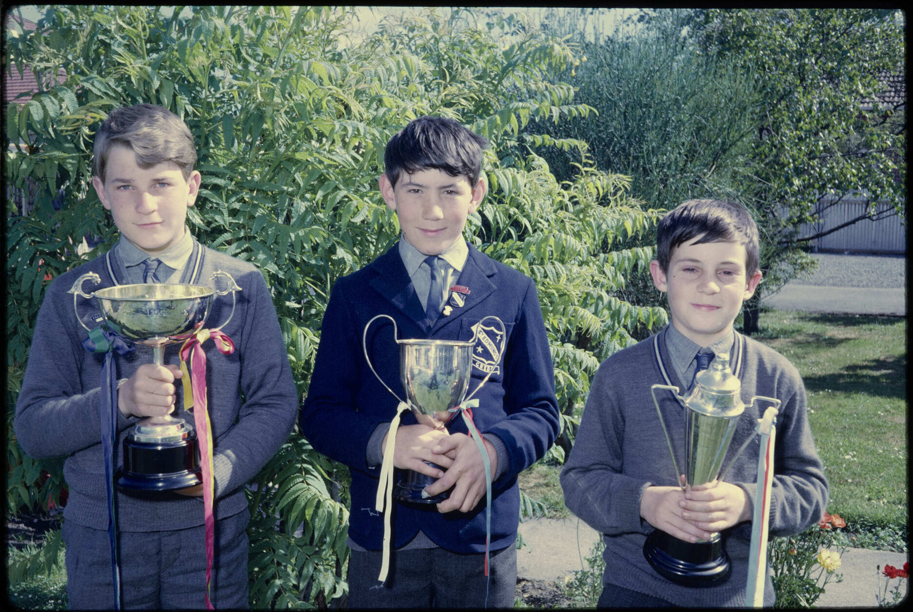Three boys with trophies