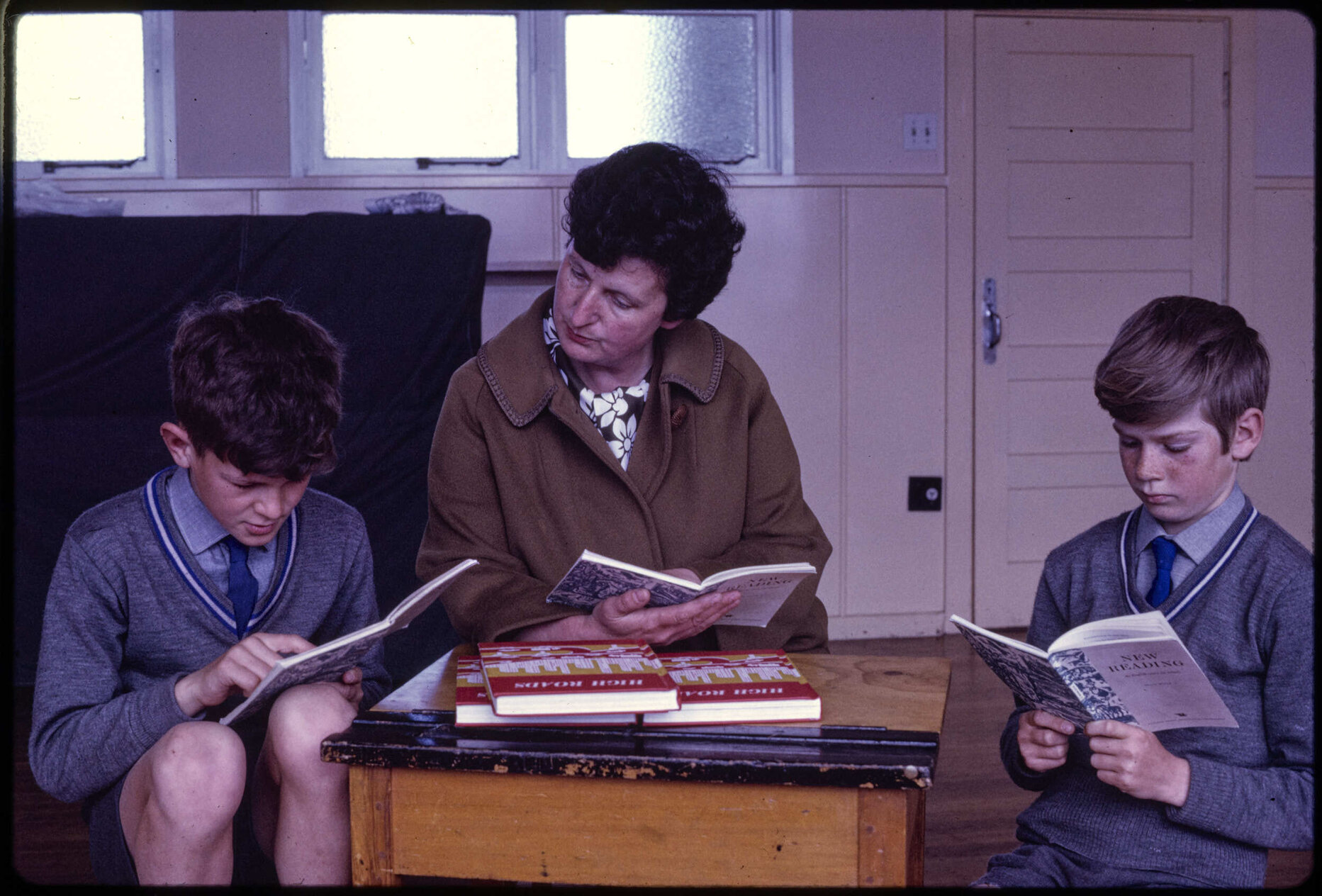 Two boys and teacher, reading