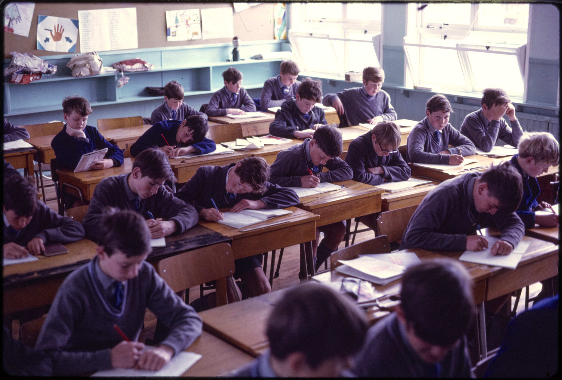 Boys seated at desks in classroom