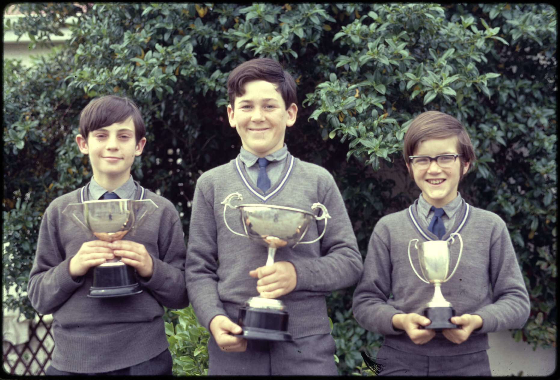 Three boys with prize cups