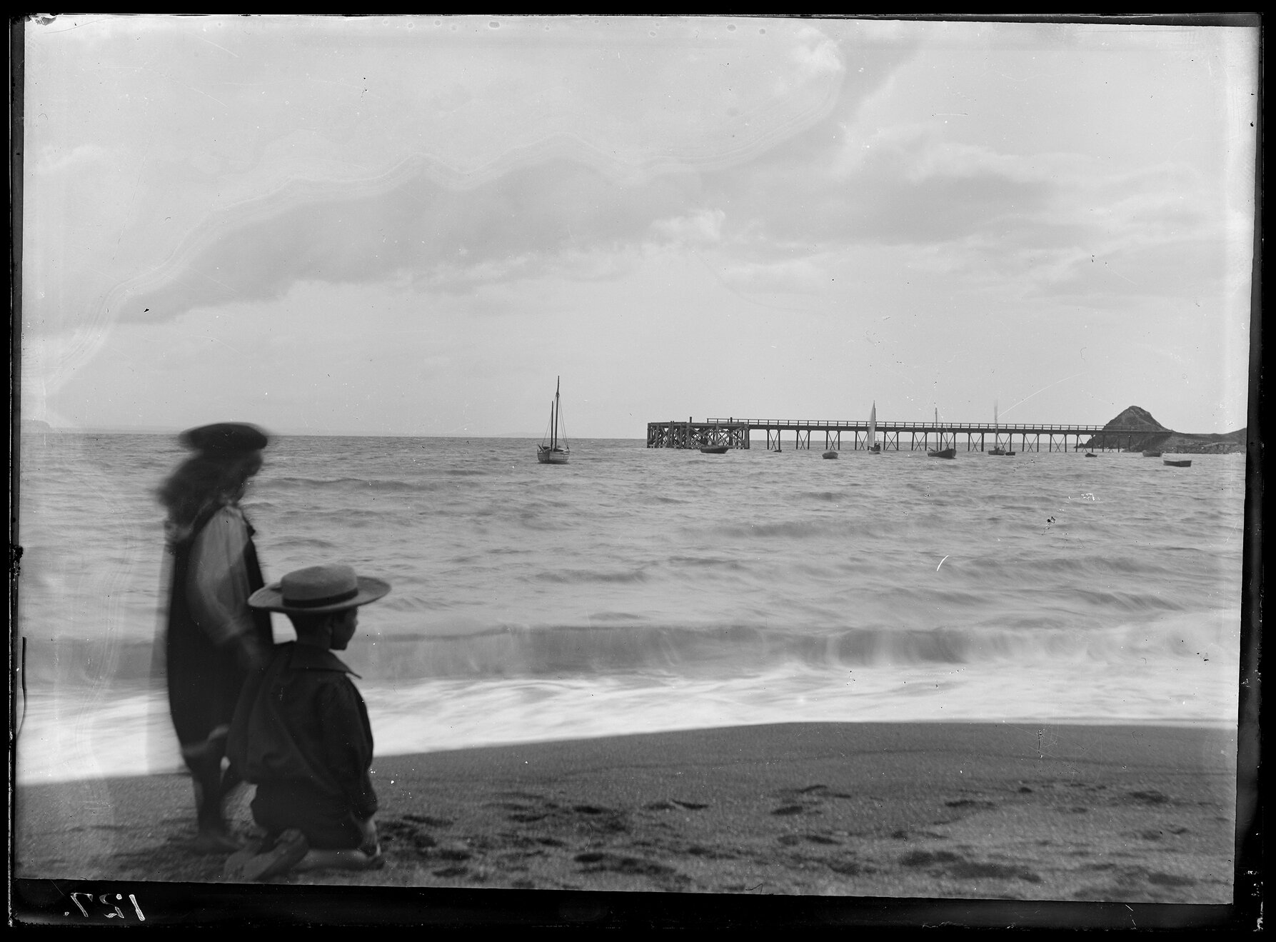 Children at beach with pier