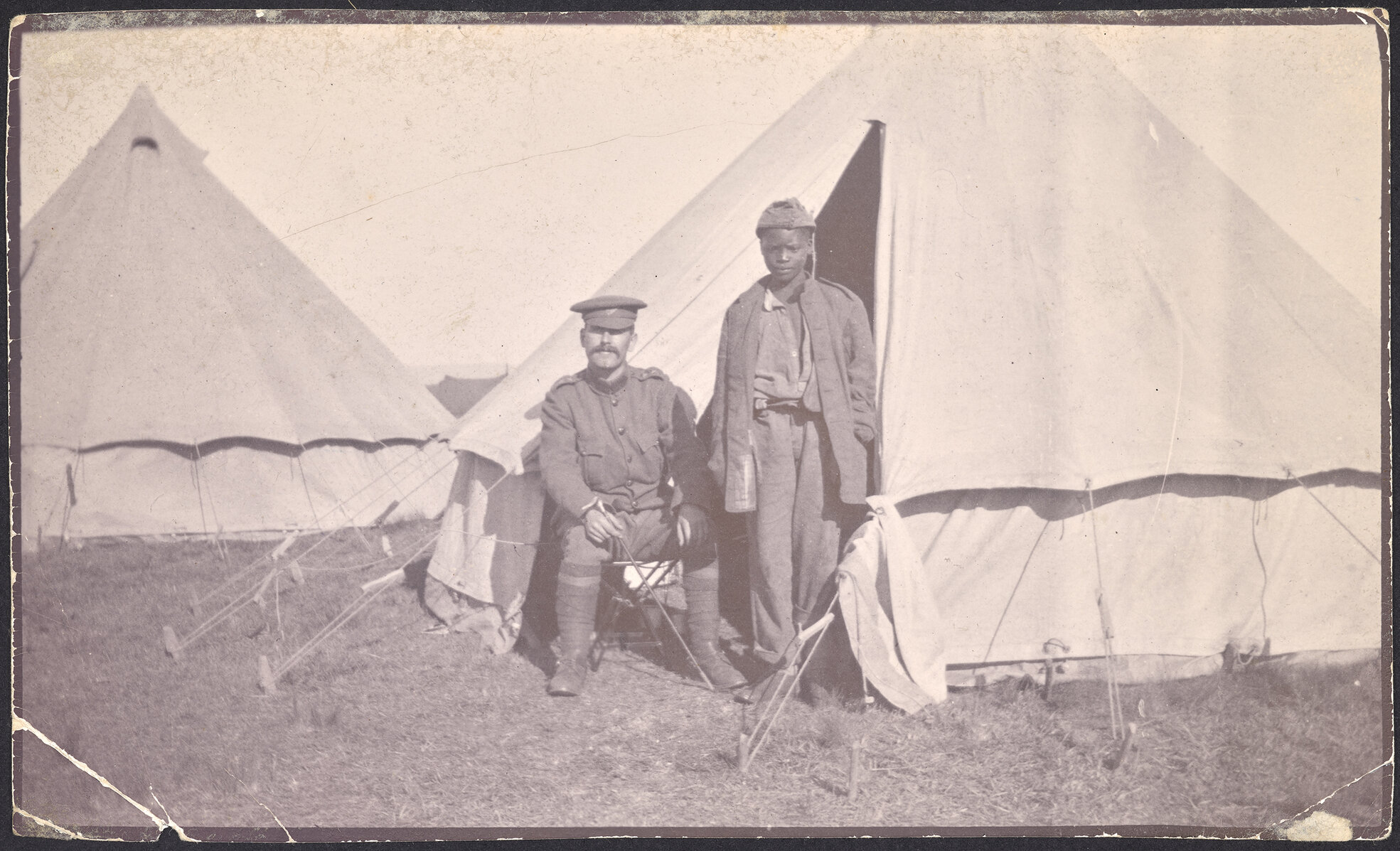 Two soldiers outside tents
