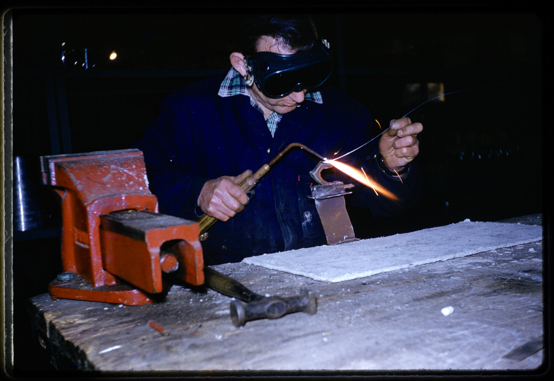 Worker using welding torch