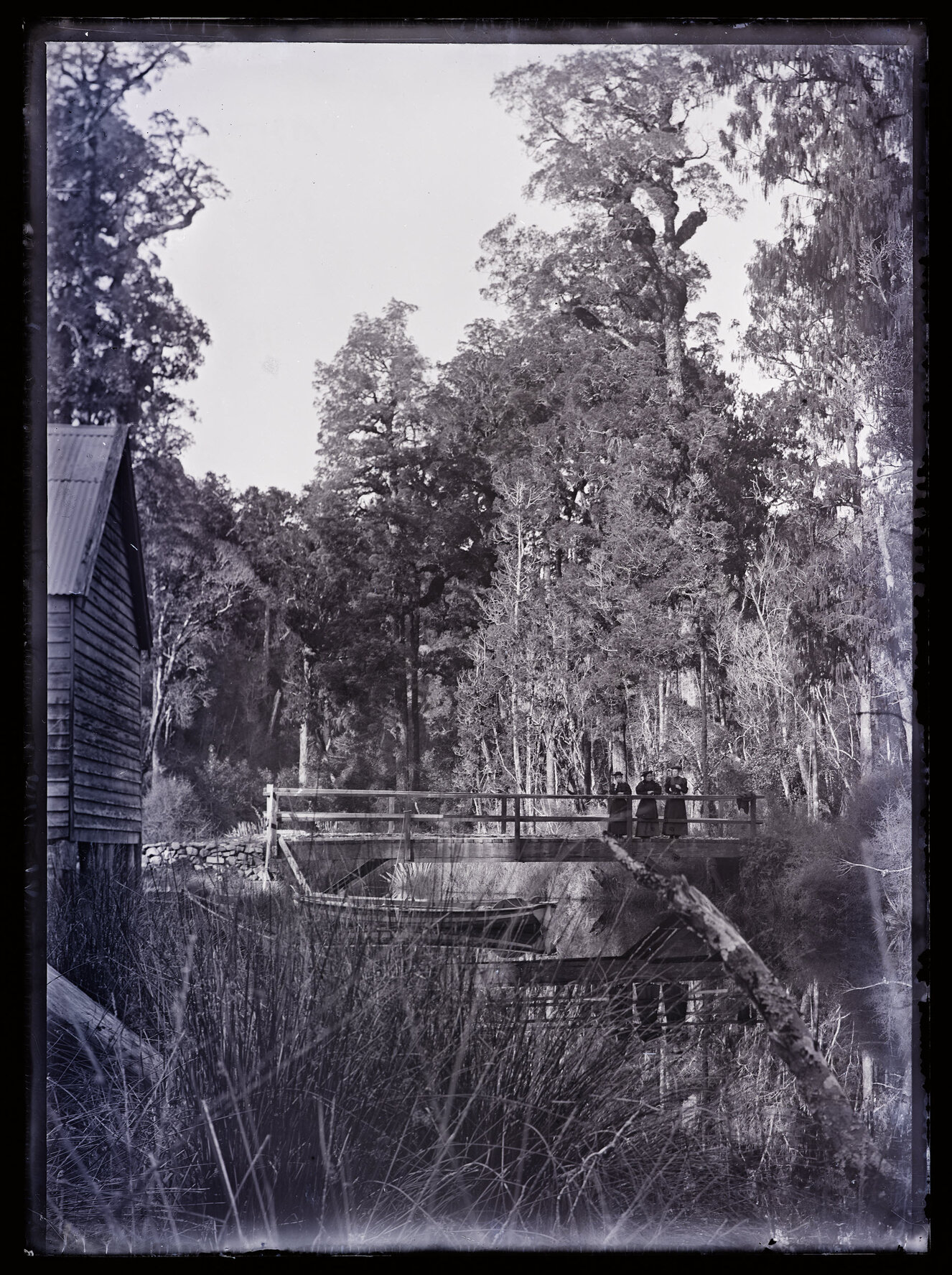 Three people on a small bridge