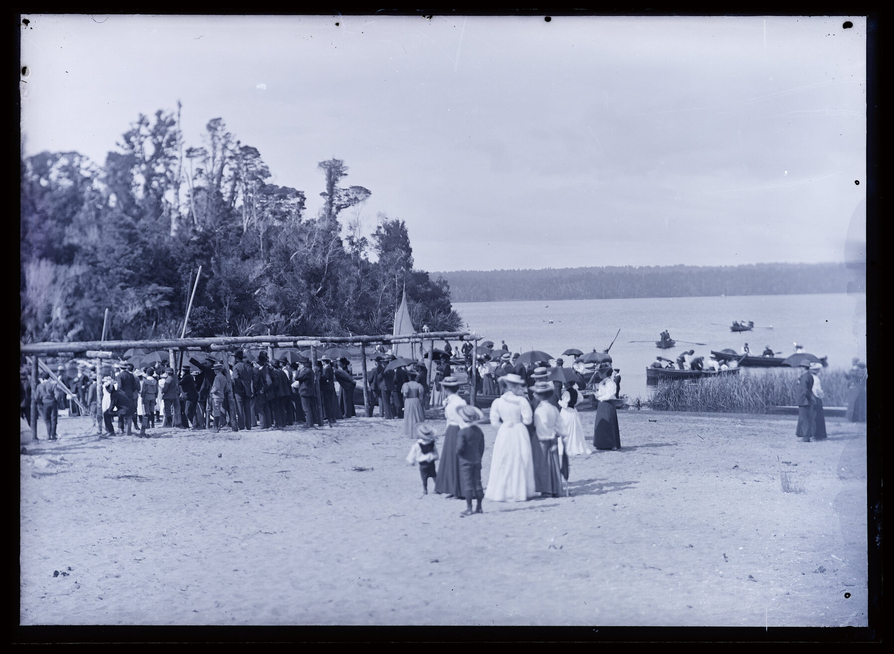 Large group of people at an event next to a lake