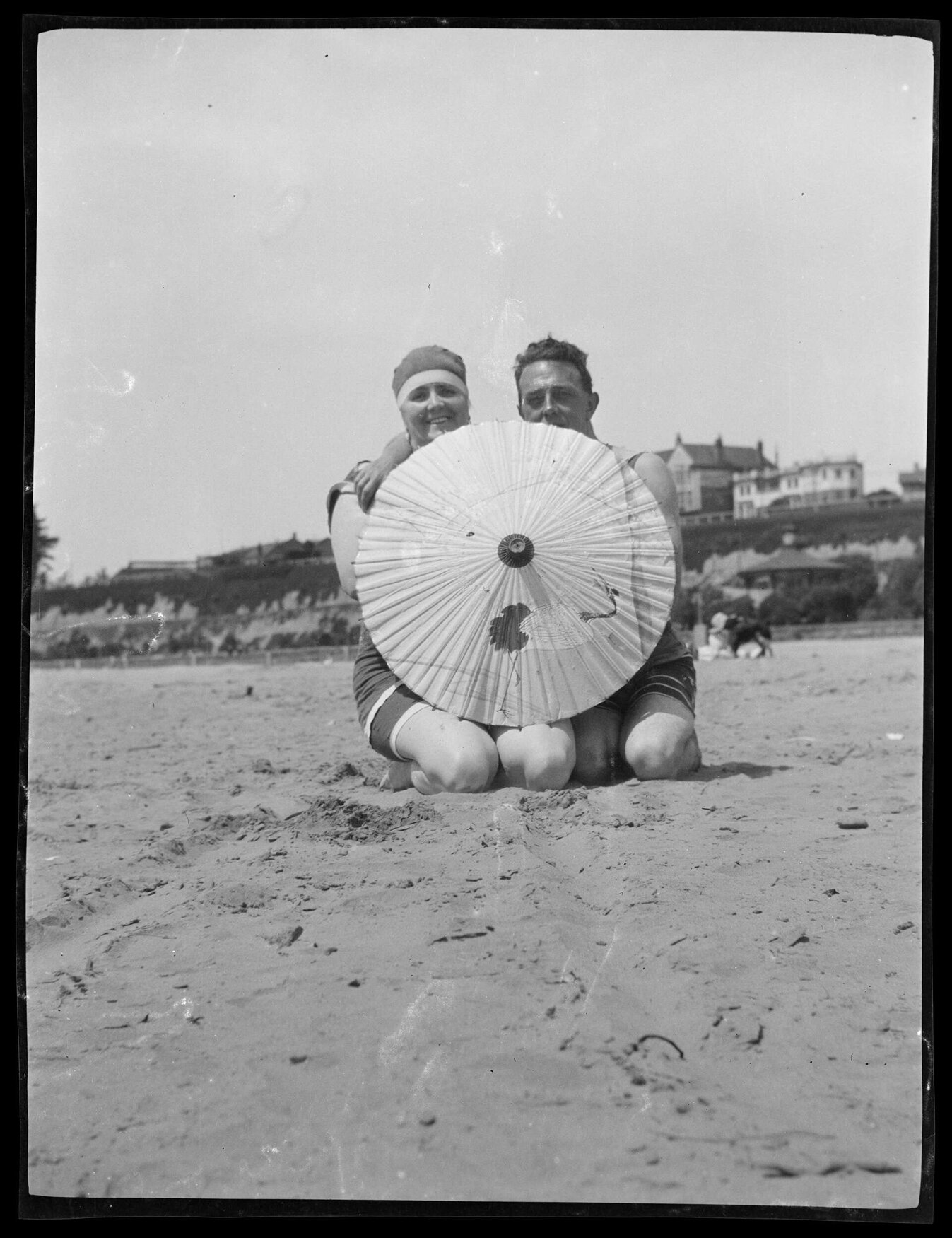 Couple behind parasol, Caroline Bay