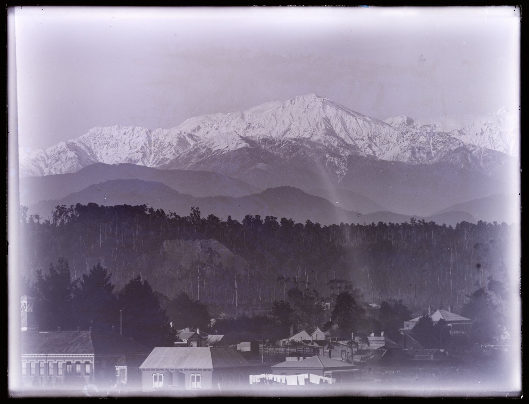 Range of snowy hills with town (Hokitika) in foreground
