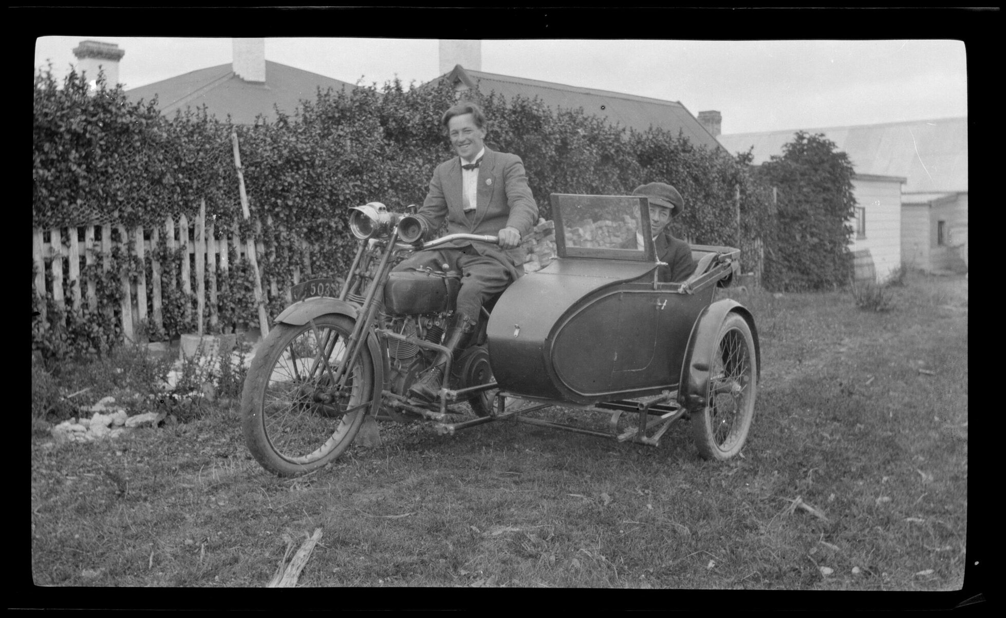 Two men with motorbike and sidecar
