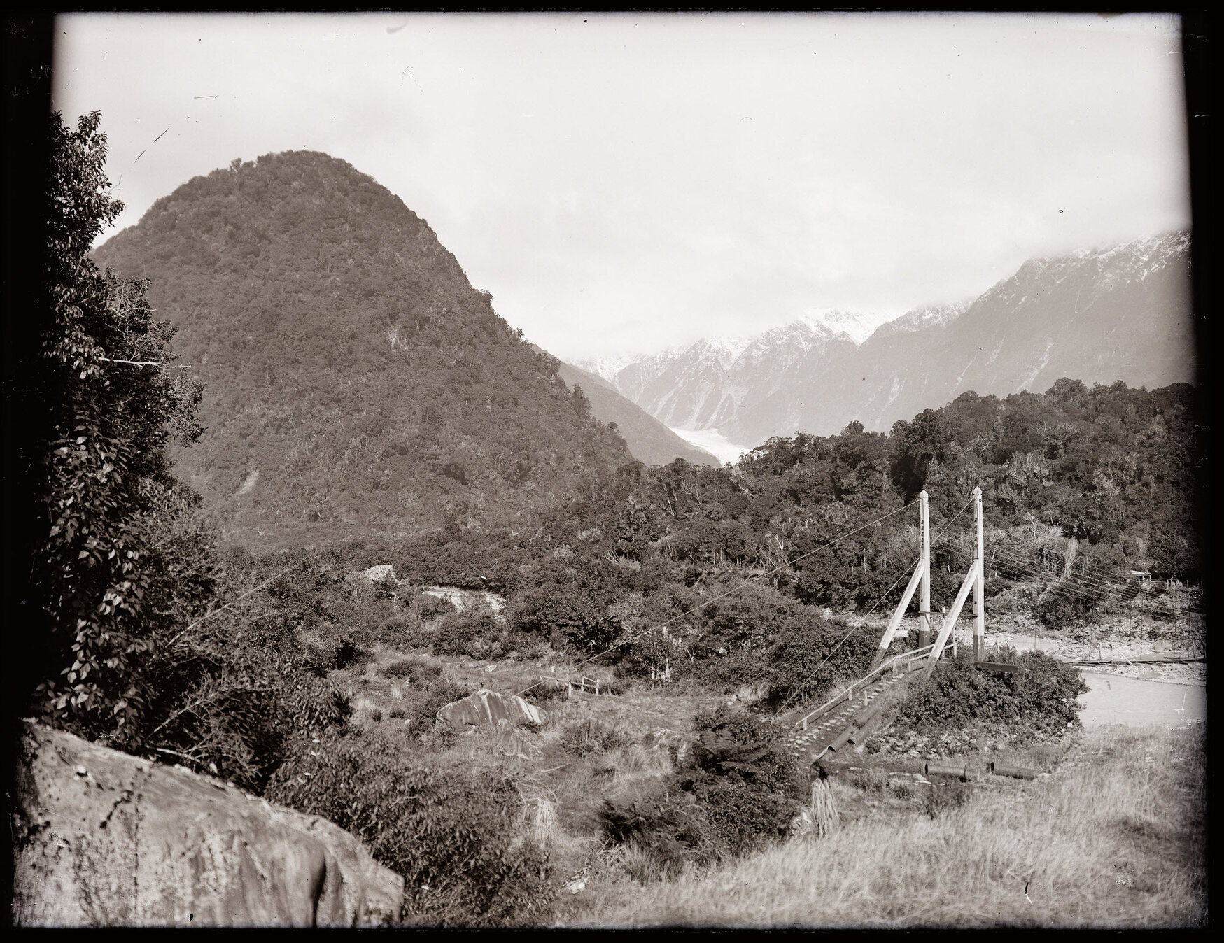 View towards Fox Glacier / Te Moeka o Tuawe showing bridge over the Fox River