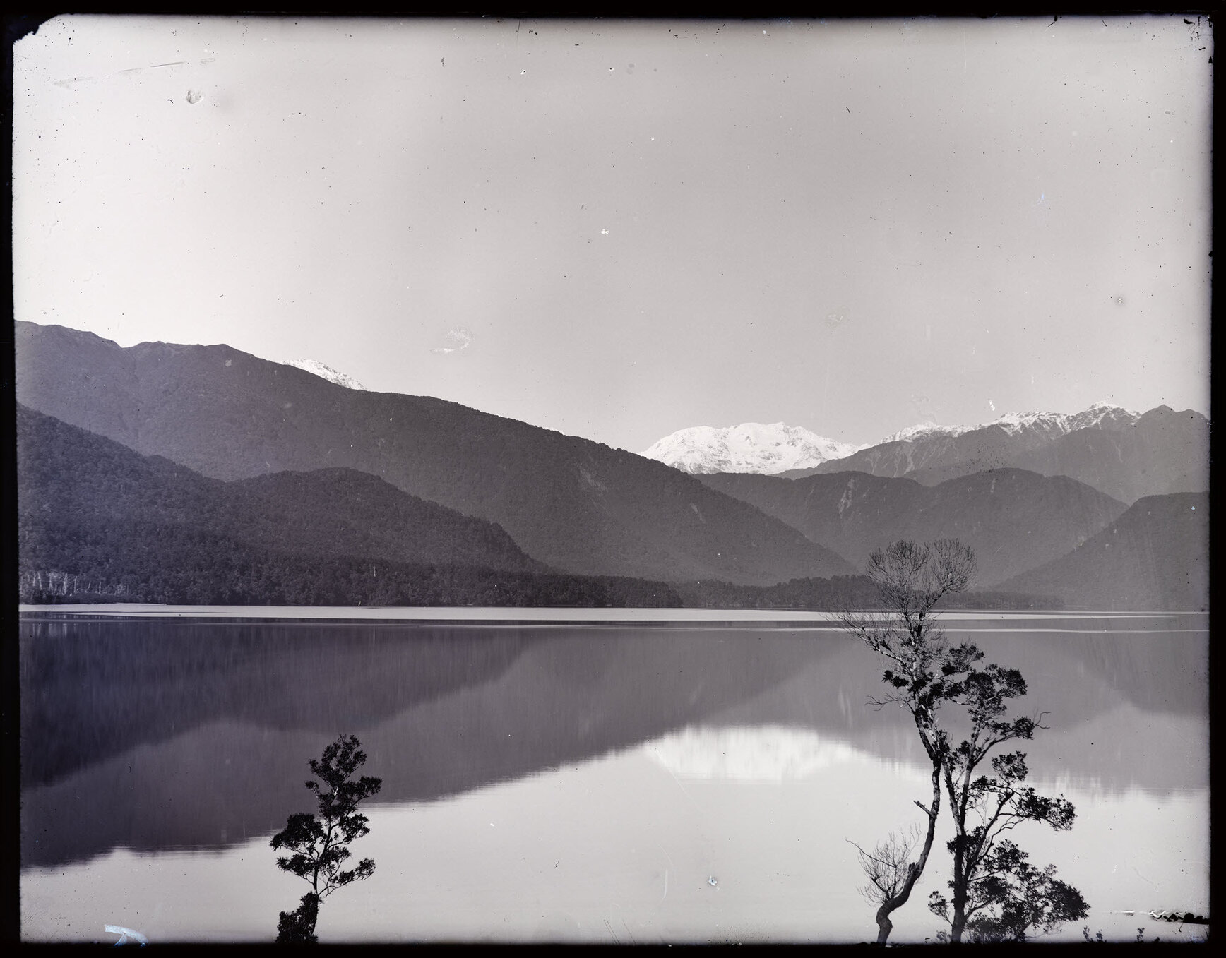 Unidentified body of water with snowy peak in background, Westland
