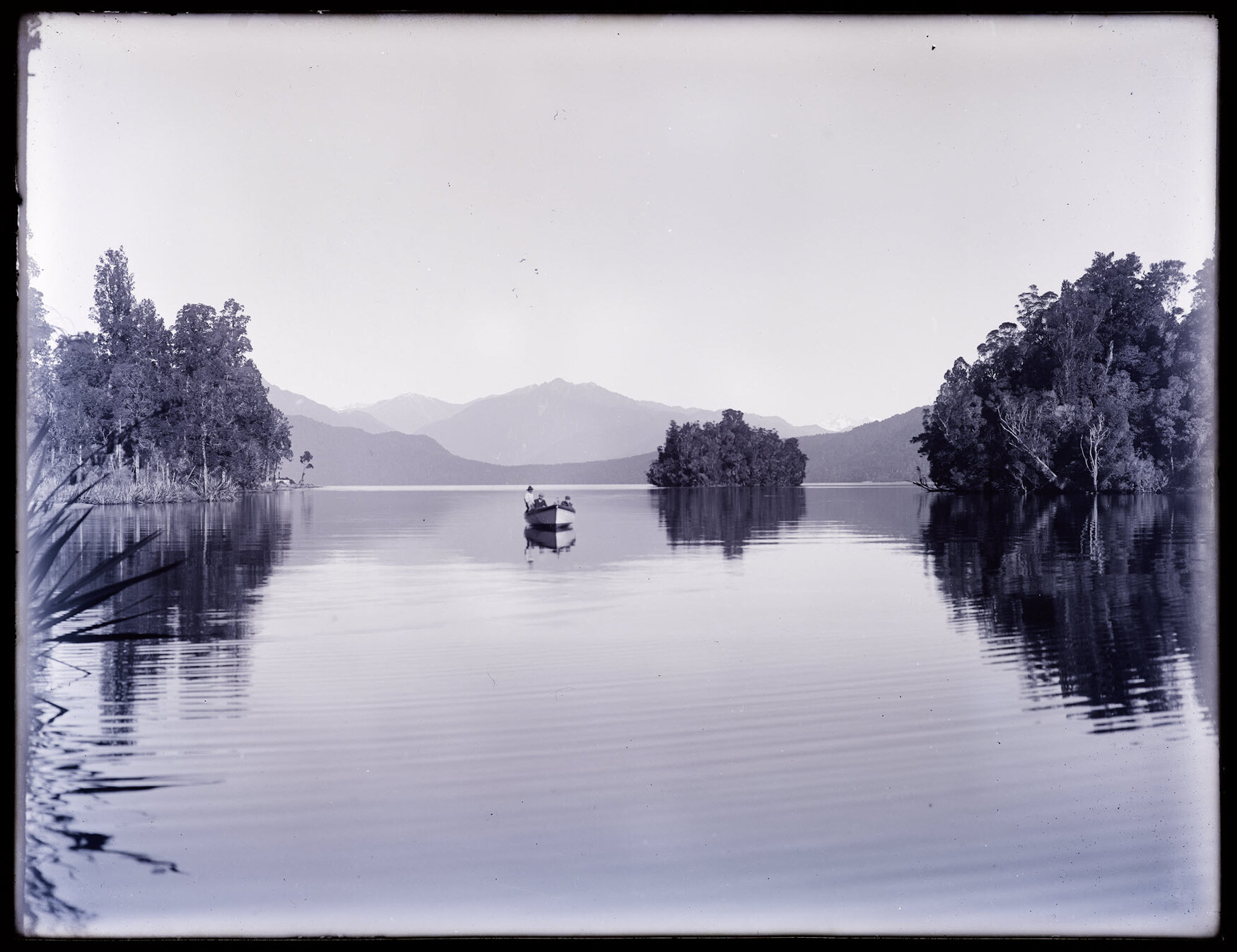 Small boat on an unidentified body of water, with small island, Westland
