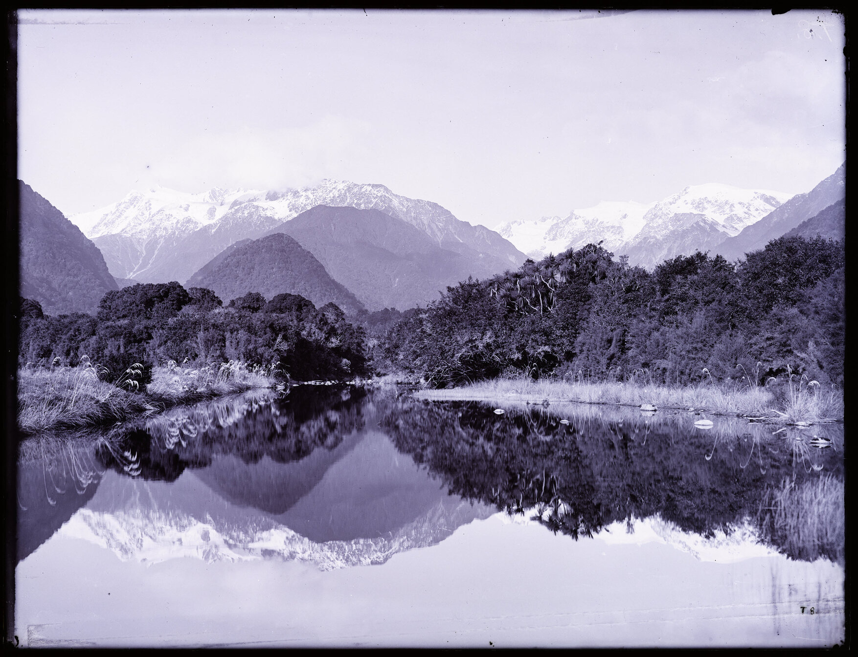 Unidentified body of water (Lake Mueller?) with snowy peaks in background