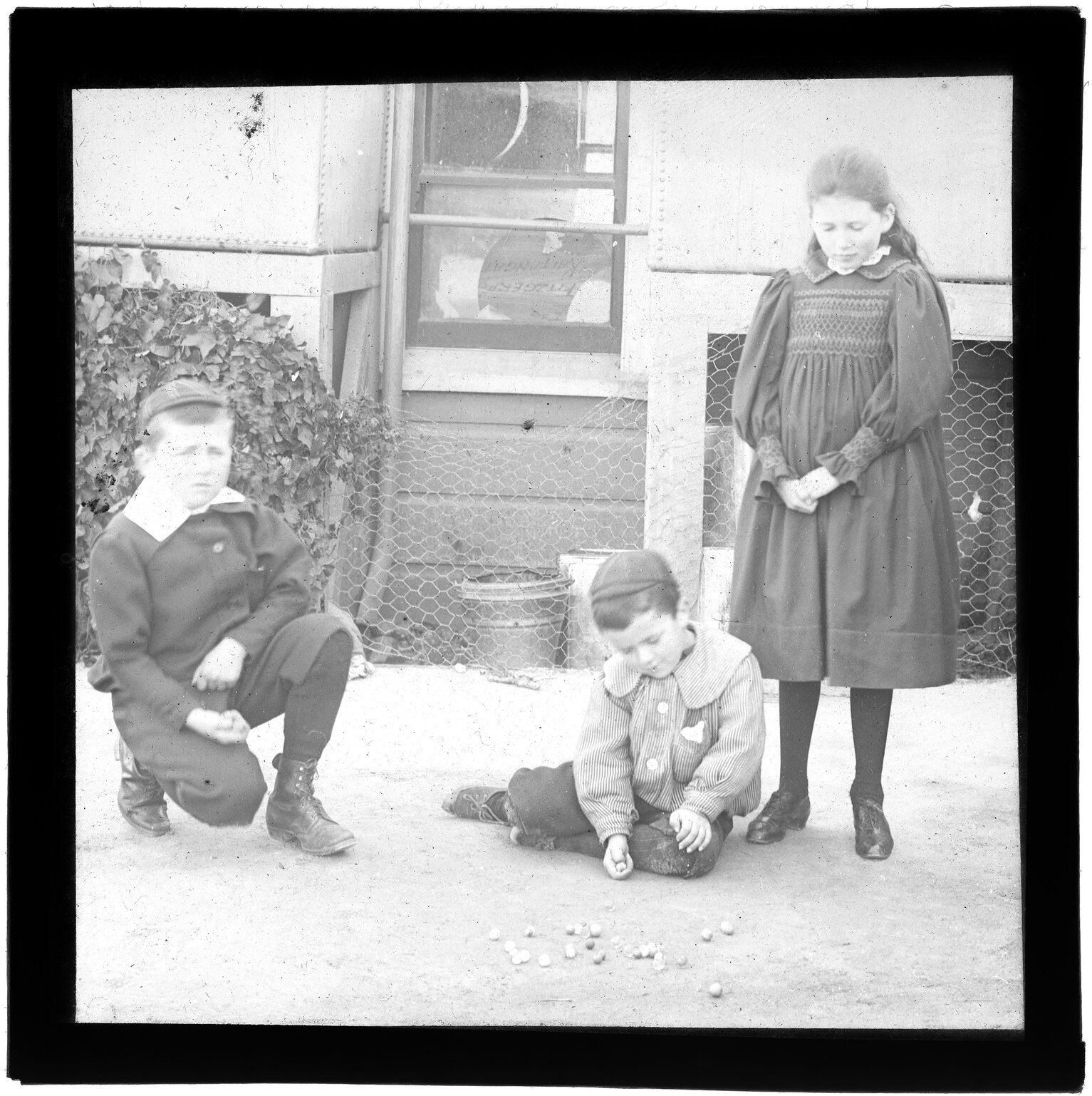Three children with marbles