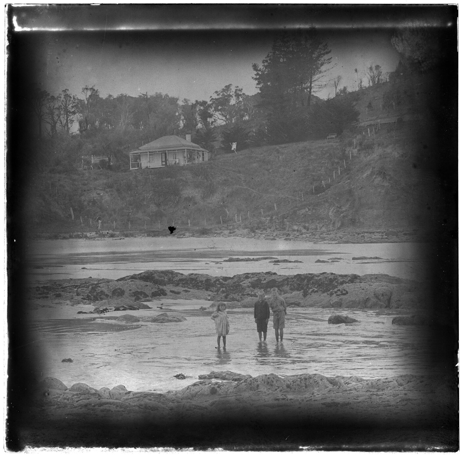 Children at beach, with hillside behind