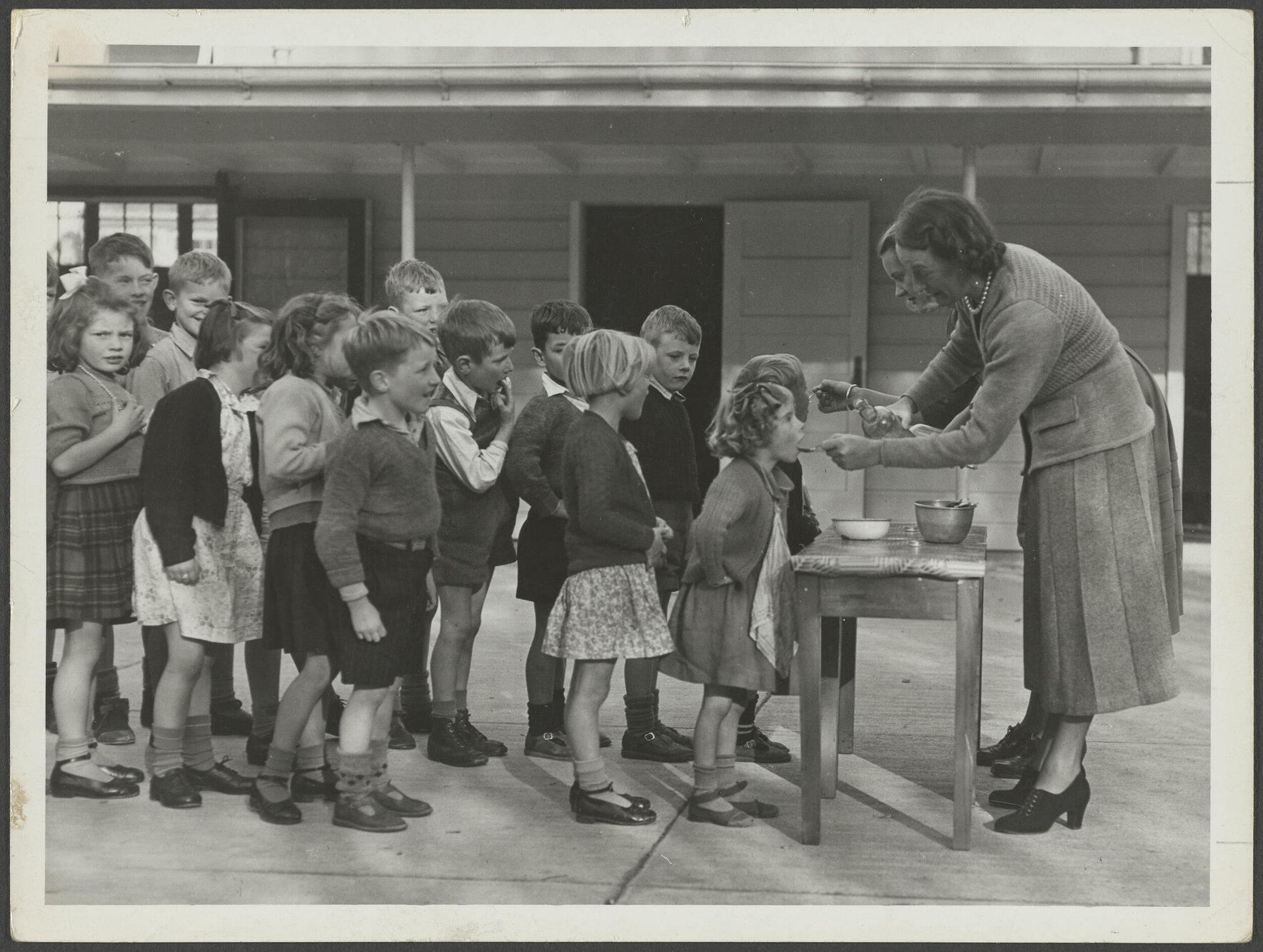 Children taking medicine at Sara Cohen School