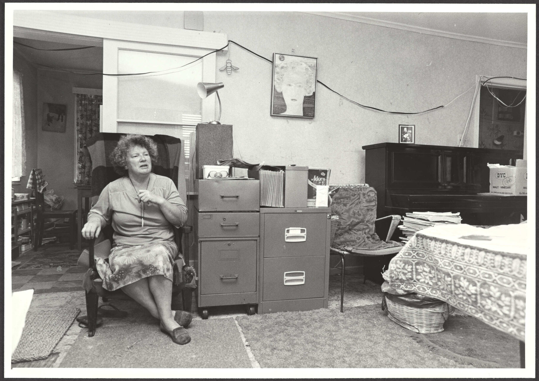 Janet Frame sitting in a room of her house