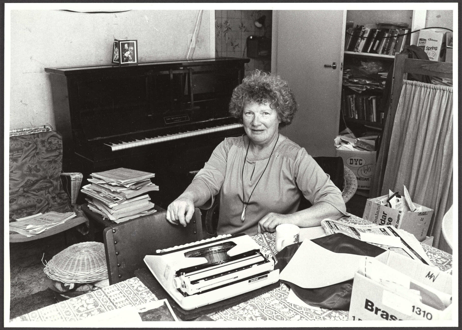 Janet Frame sitting at a table