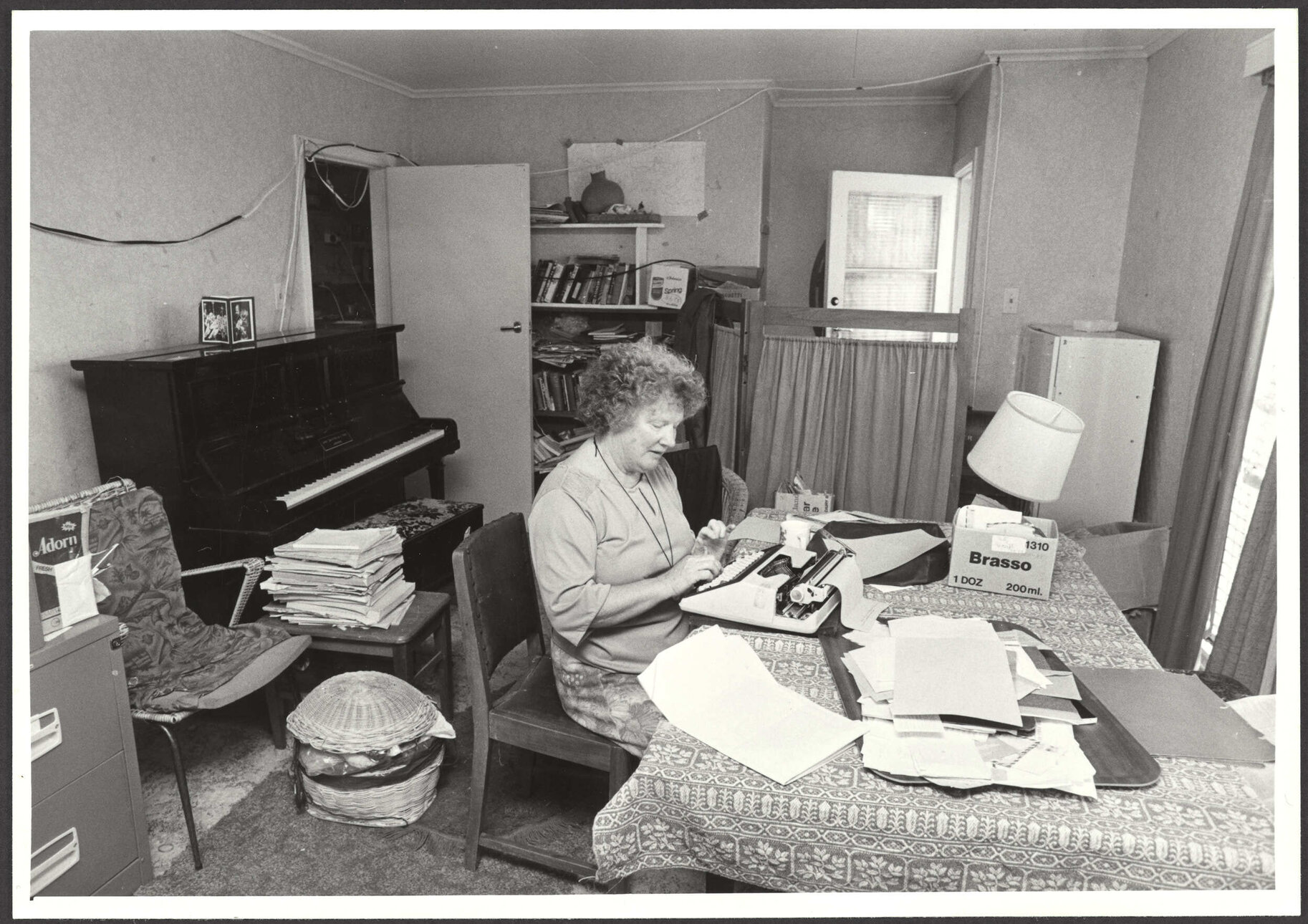 Janet Frame typing in a room in her house