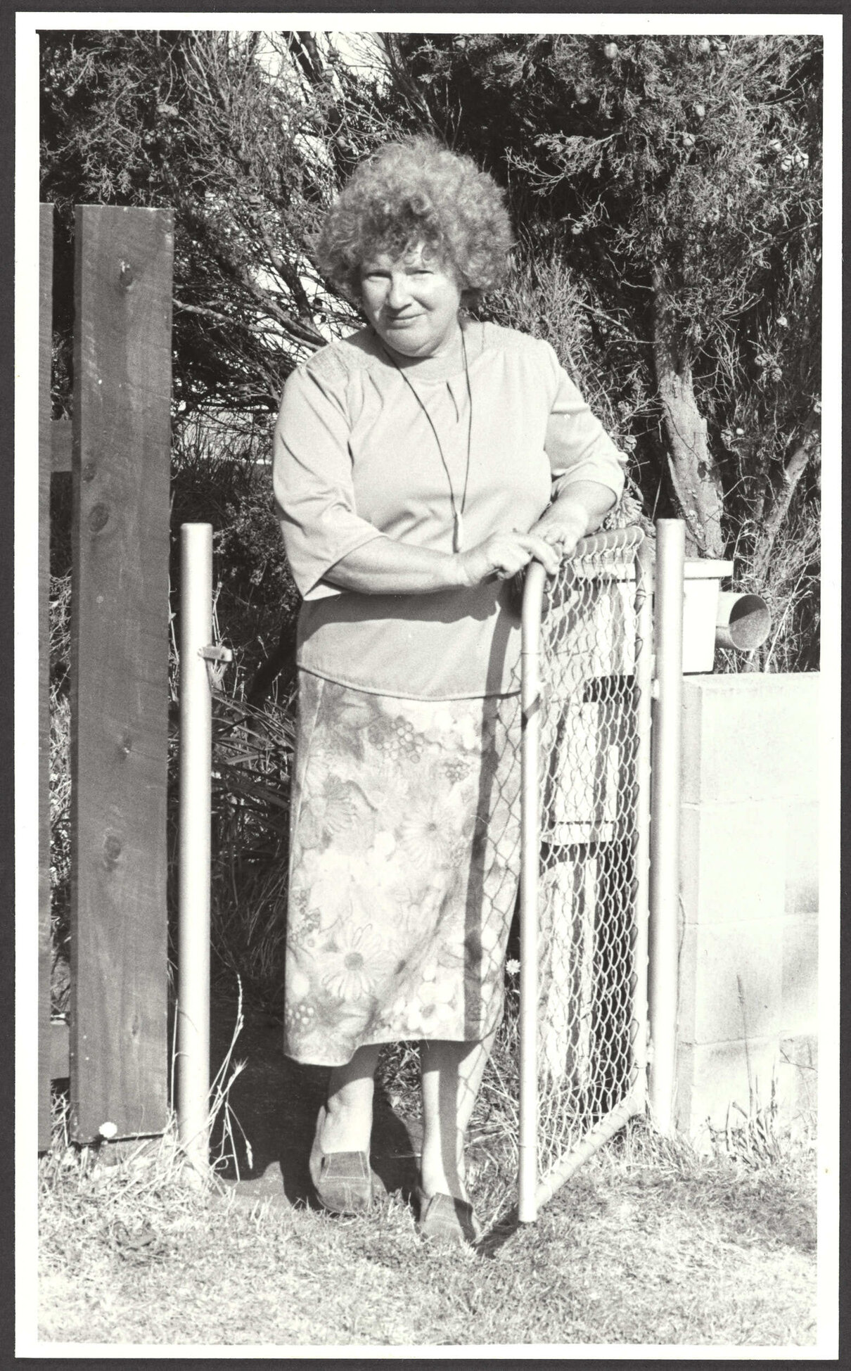 Janet Frame standing at gate