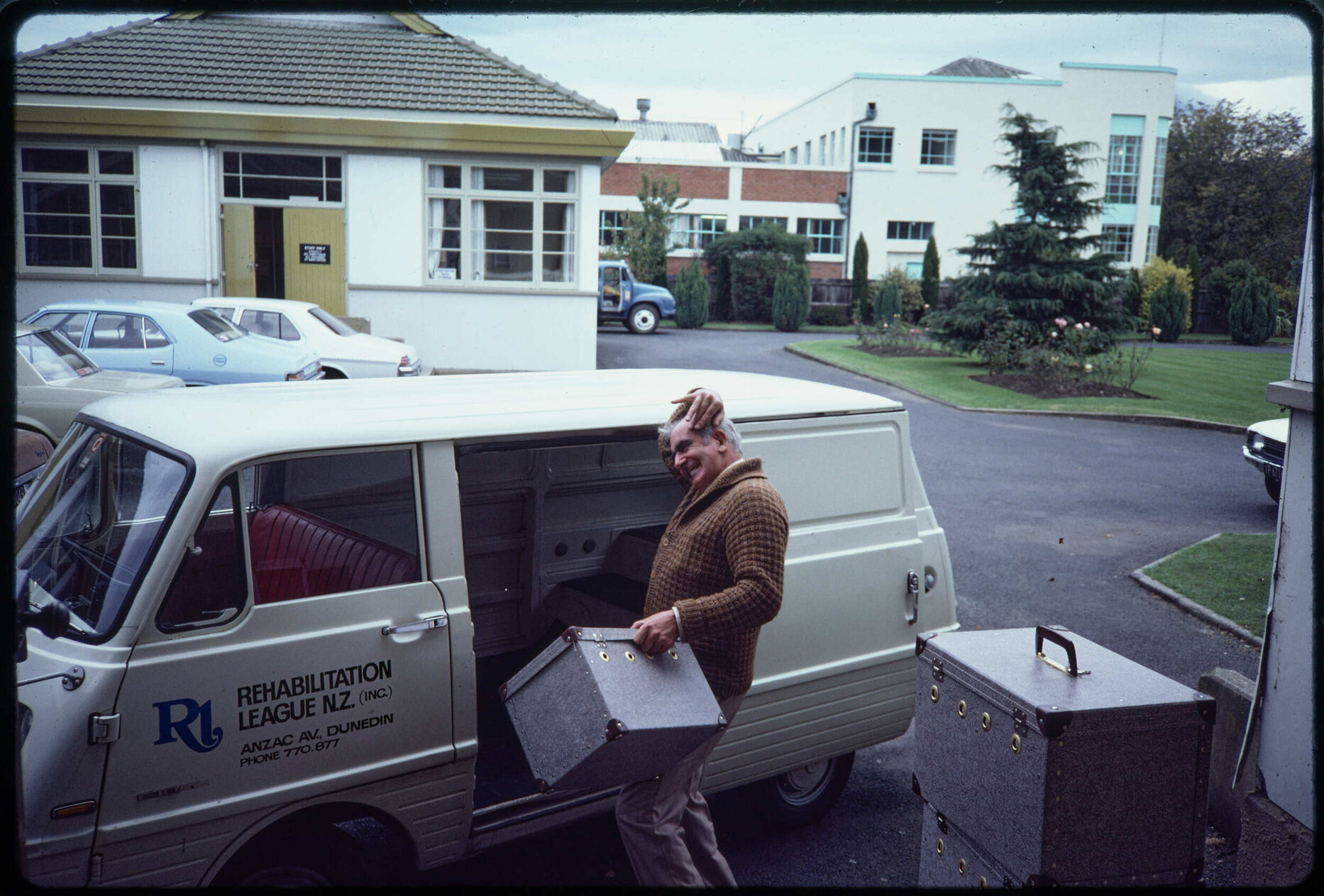 Man with cases and Rehabilitation League van