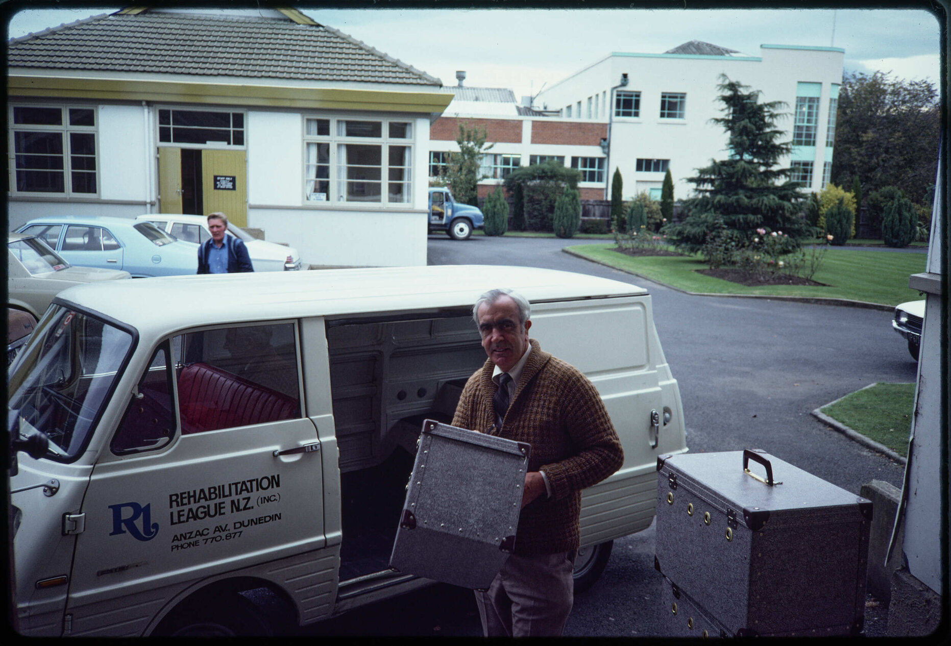 Man with cases and Rehabilitation League van