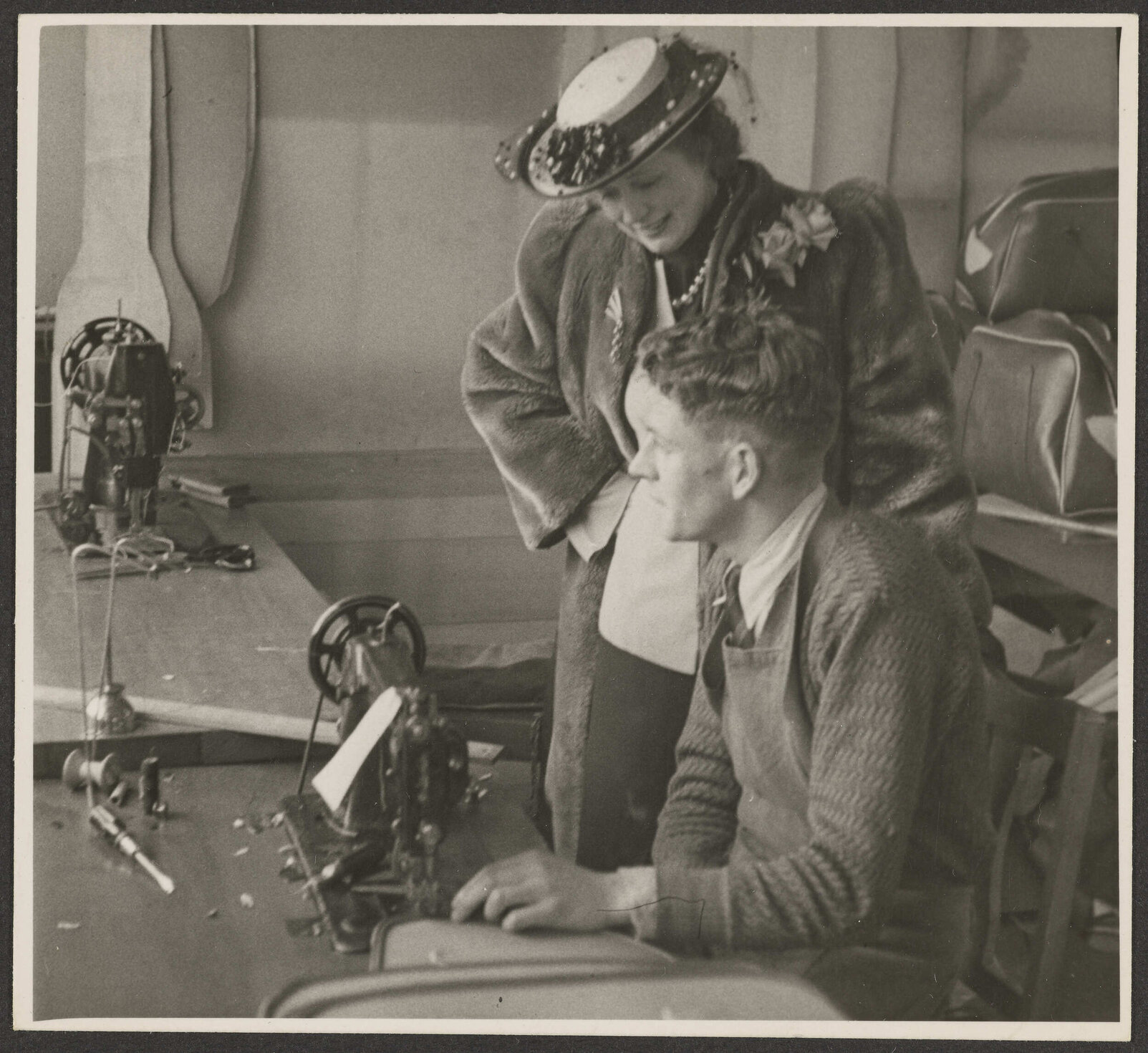 Nola Luxford with returned serviceman in leather goods department