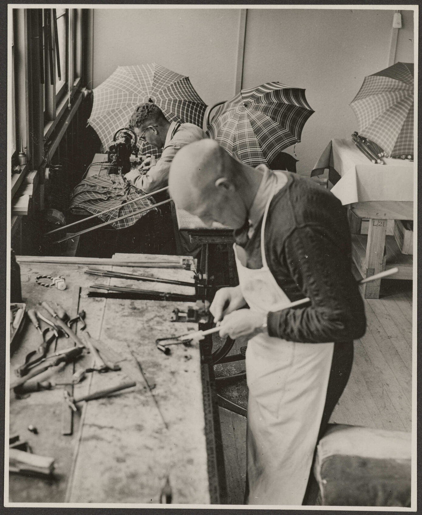 Two men making umbrellas