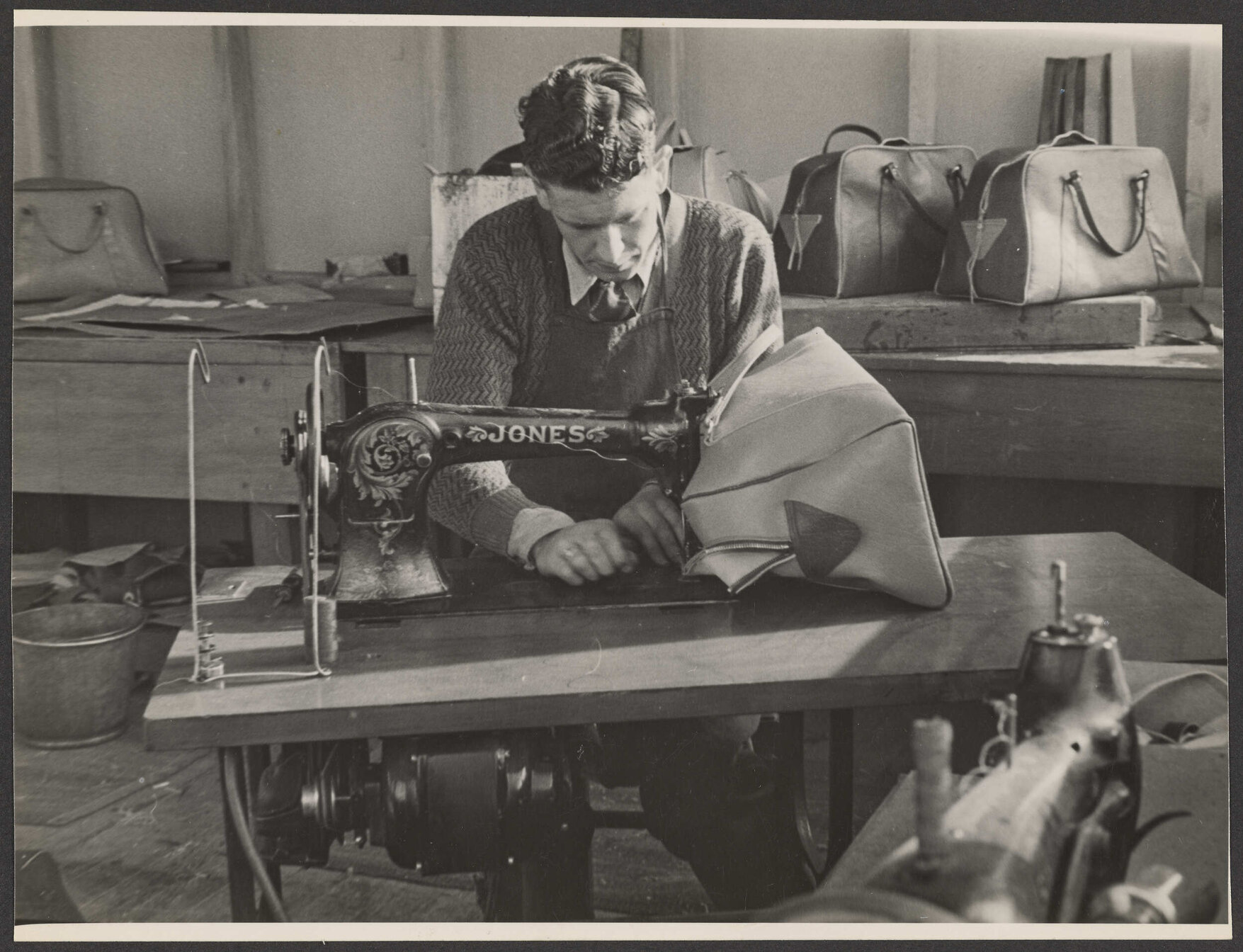 Bob Cogland (?) sewing a leather bag