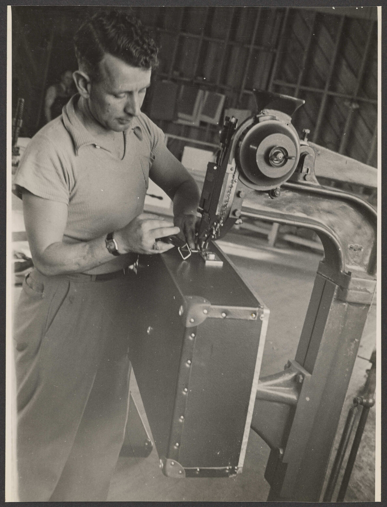 Worker making a suitcase