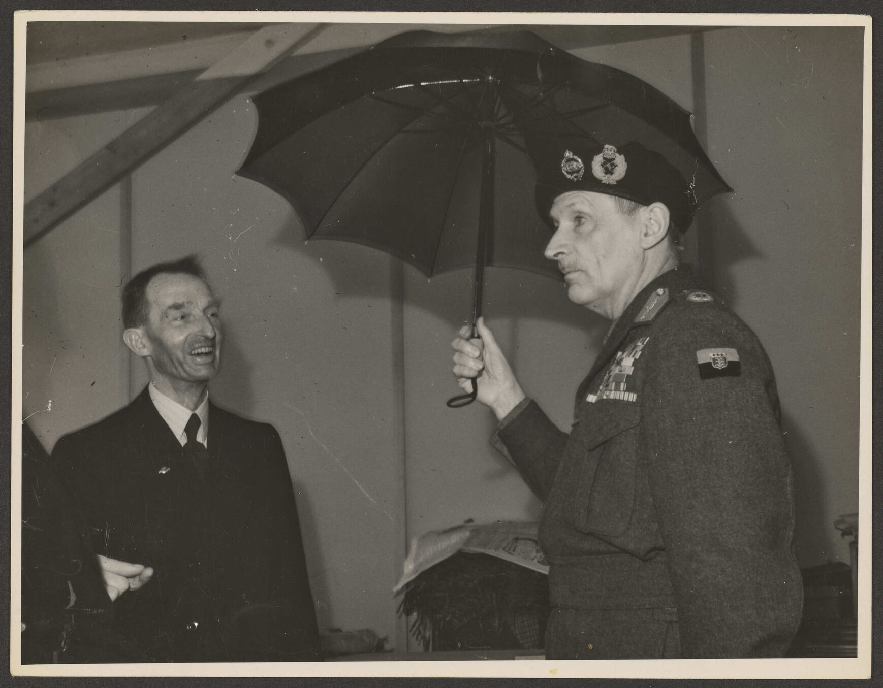 Lord Montgomery holding an umbrella at the Disabled Servicemen's Vocational Training Centre