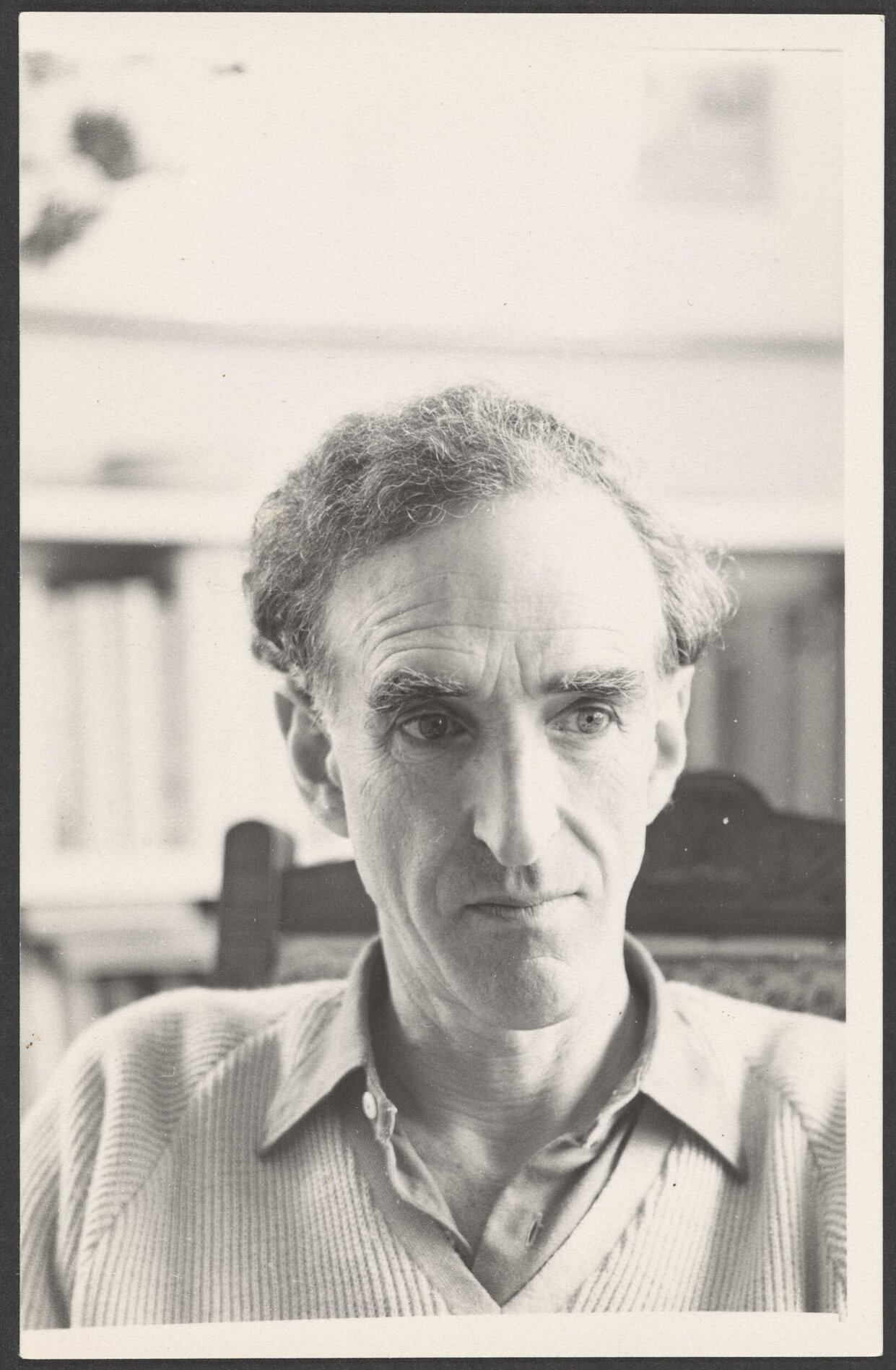 Charles Brasch in a chair