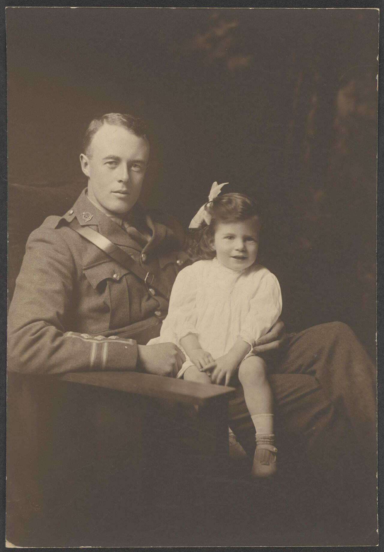 Unidentified man in uniform with young girl