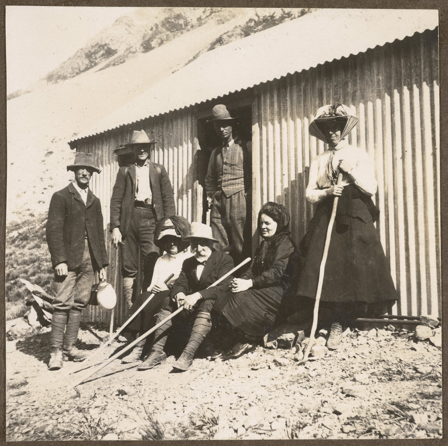 Party at Hooker Hut. Dorothy Theomin at right, David Theomin at centre, Peter Graham in hut door.