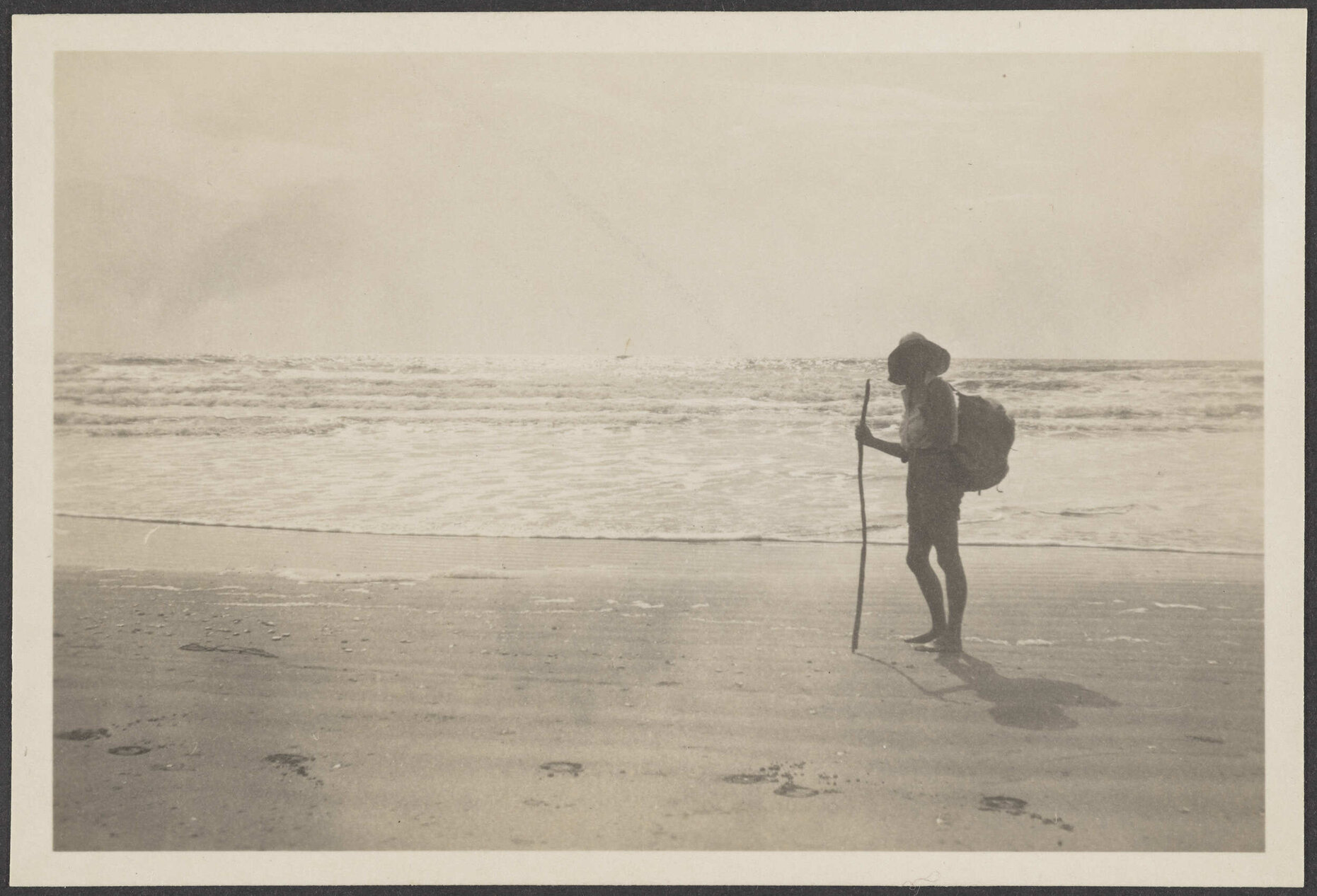 Unidentified woman standing on a beach