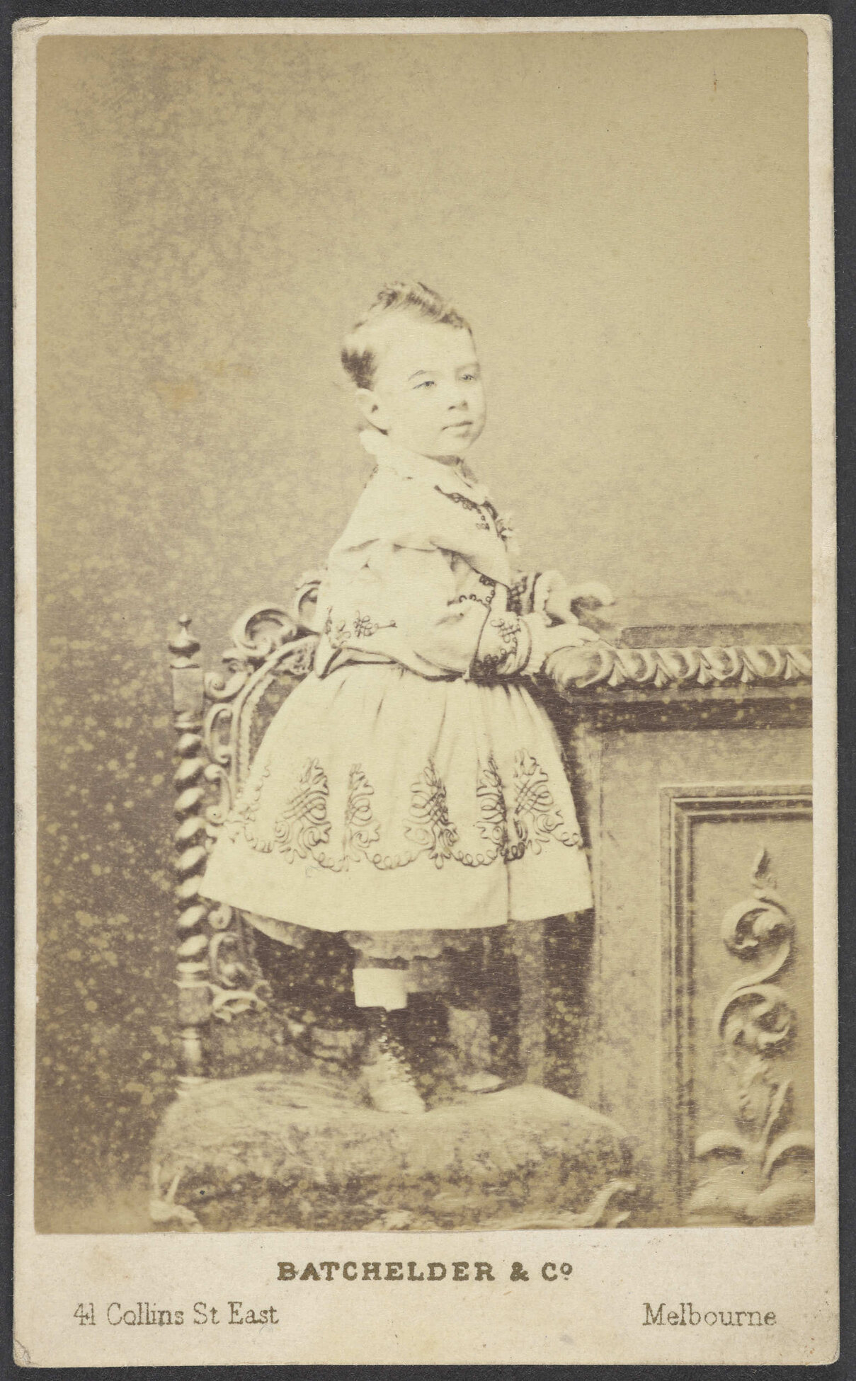 Young child standing on chair