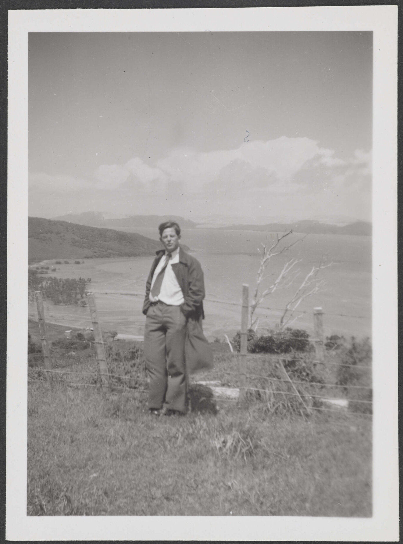 Man with coastal view behind