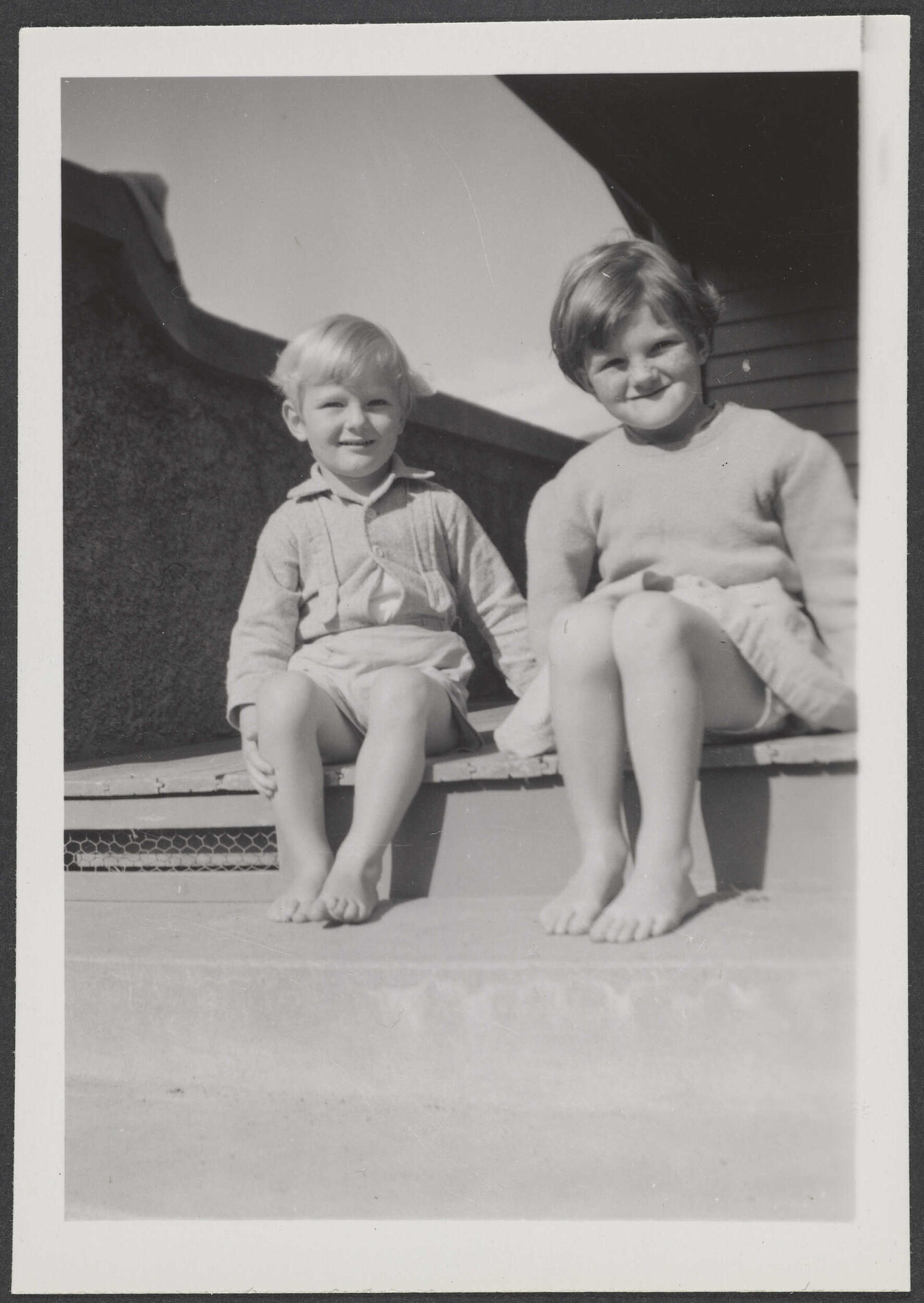 Two of the Thompson children on a step
