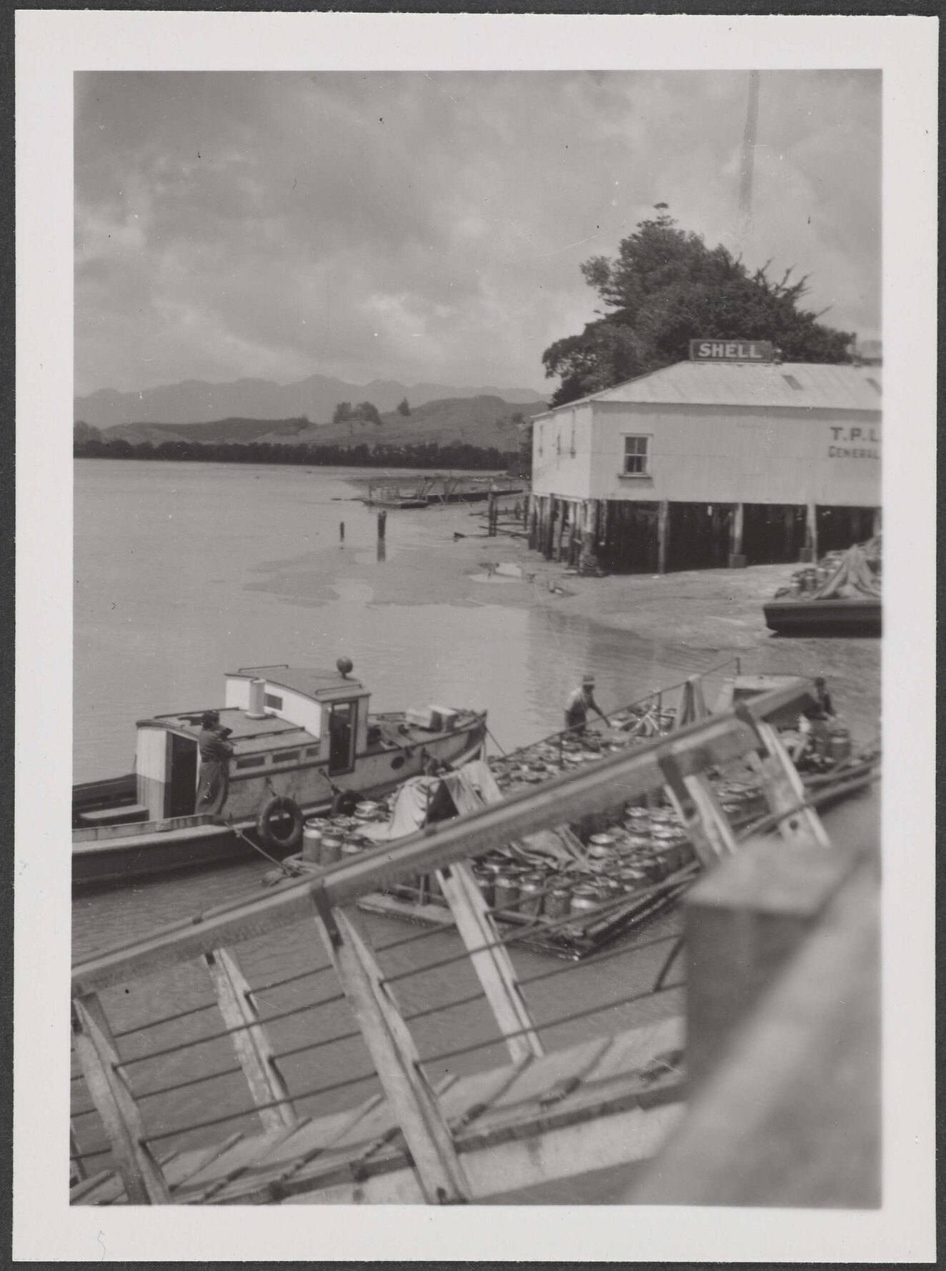 Foreshore at Rawene, including boat and store building