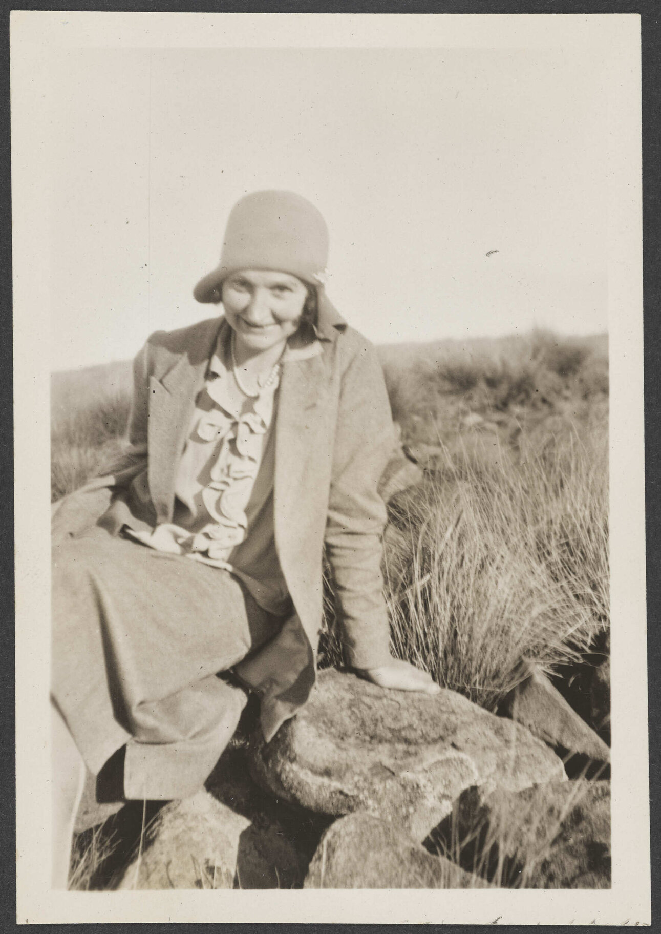 Unidentified woman sitting on rocks