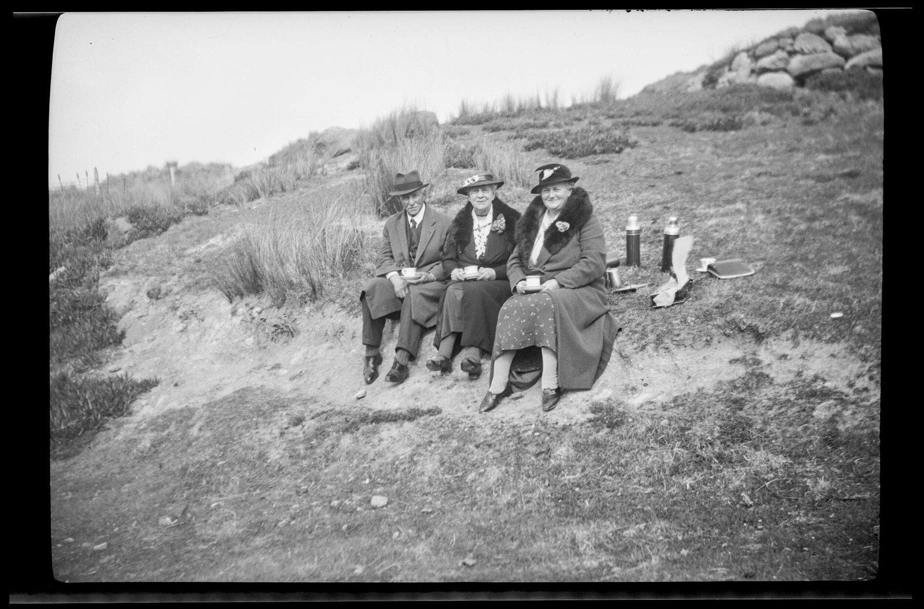 Three people sitting outside