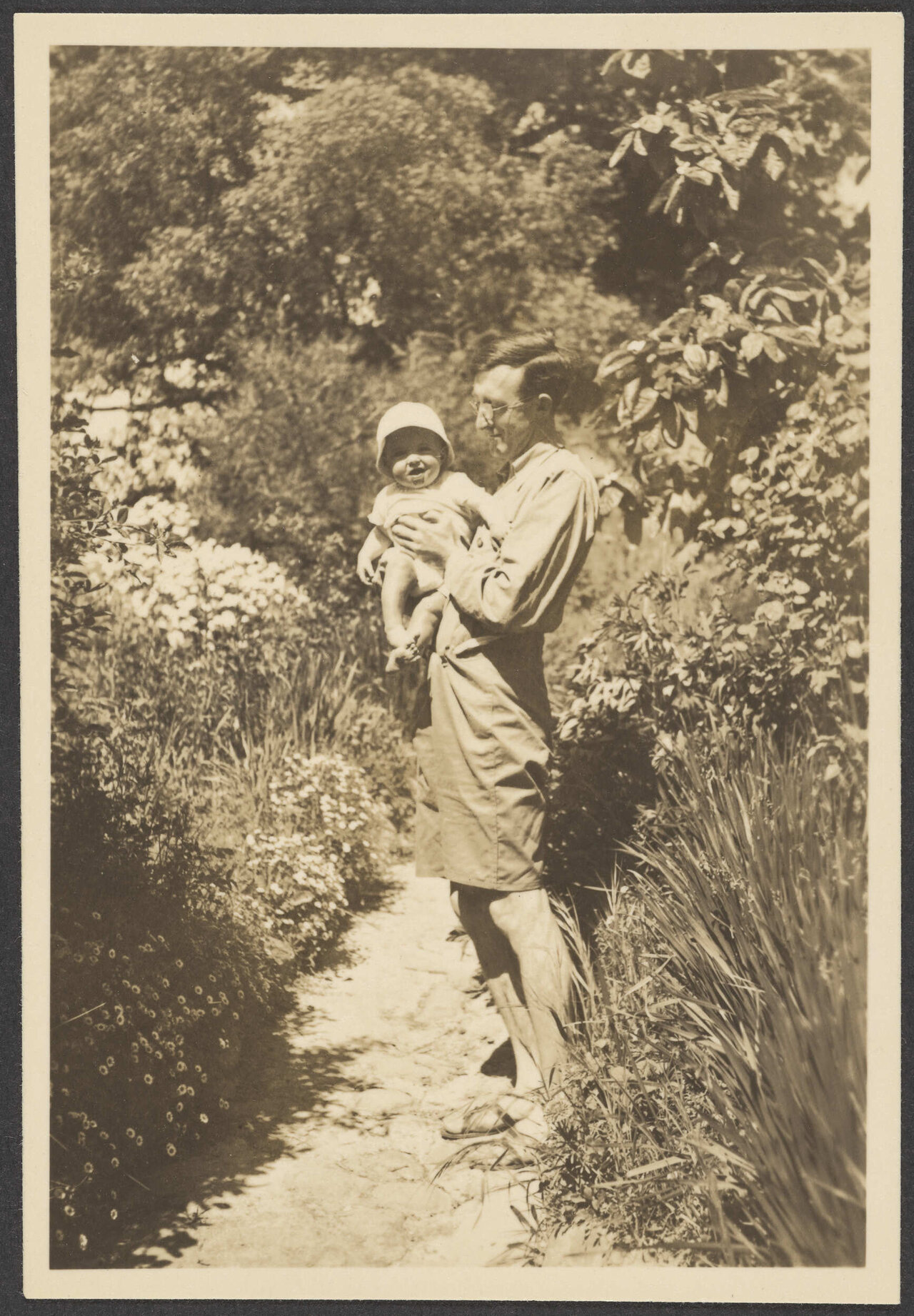 Man in a garden with a baby