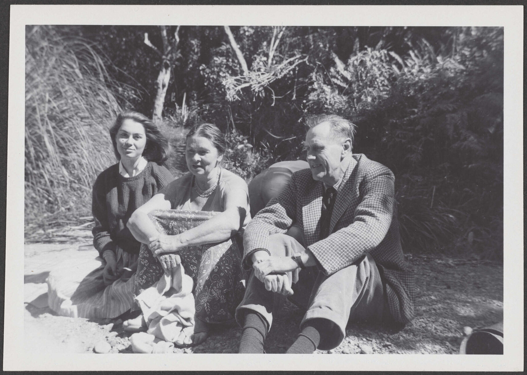 [? Garland], Peggy Garland, and Patrick White, sitting outside