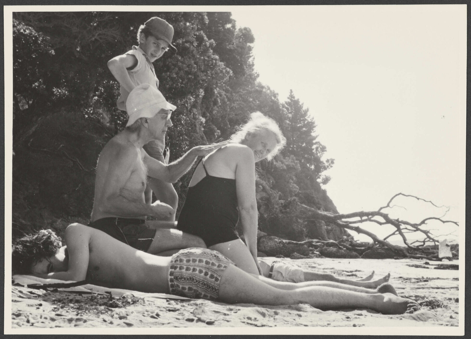 Jack and Gwyneth Bennett with two boys on a beach