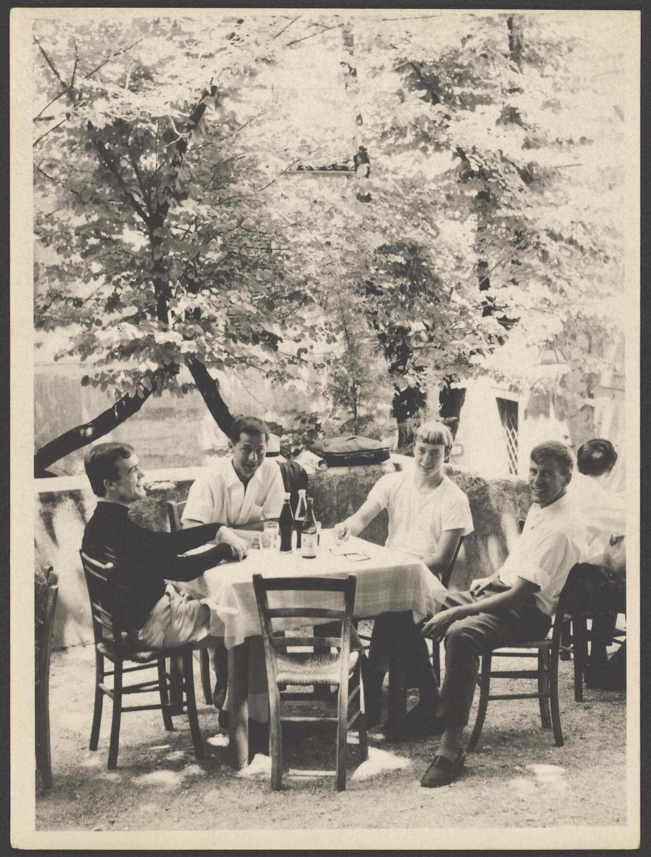 Unidentified men dining outdoors