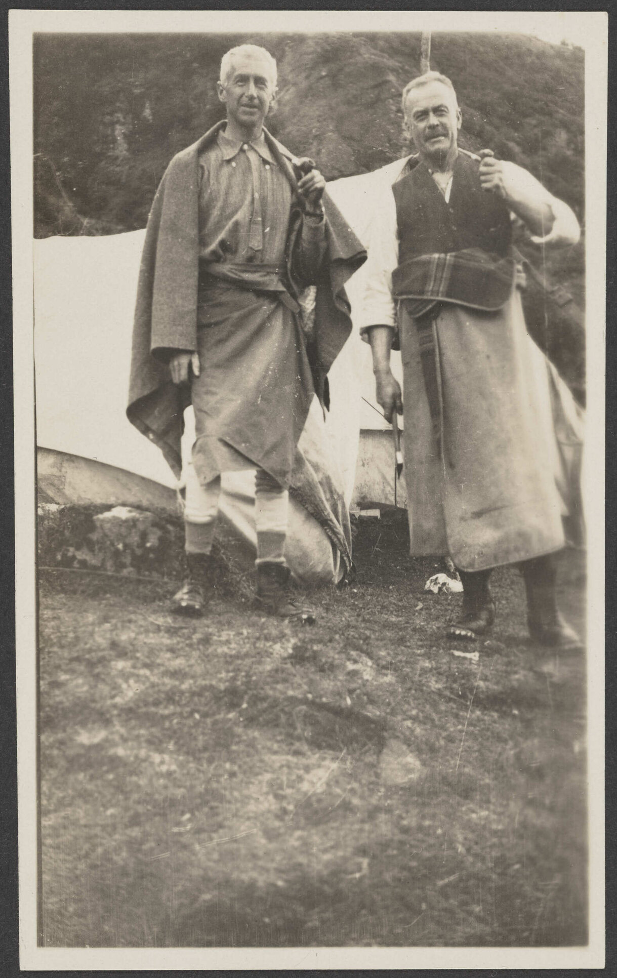 Two men in front of tent